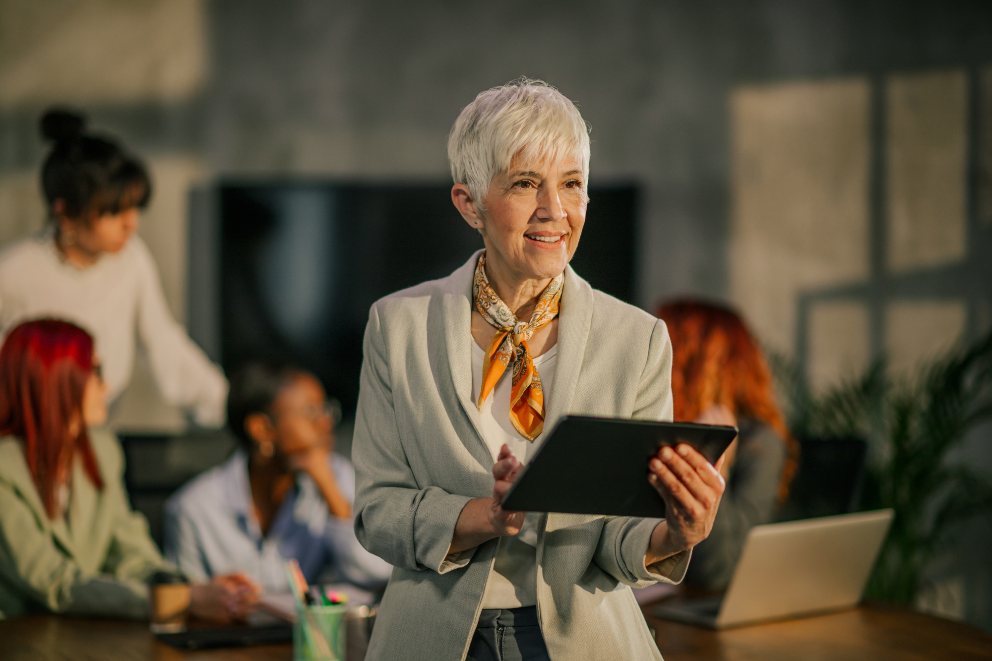 Senior businesswoman with tablet in hands working on business strategy