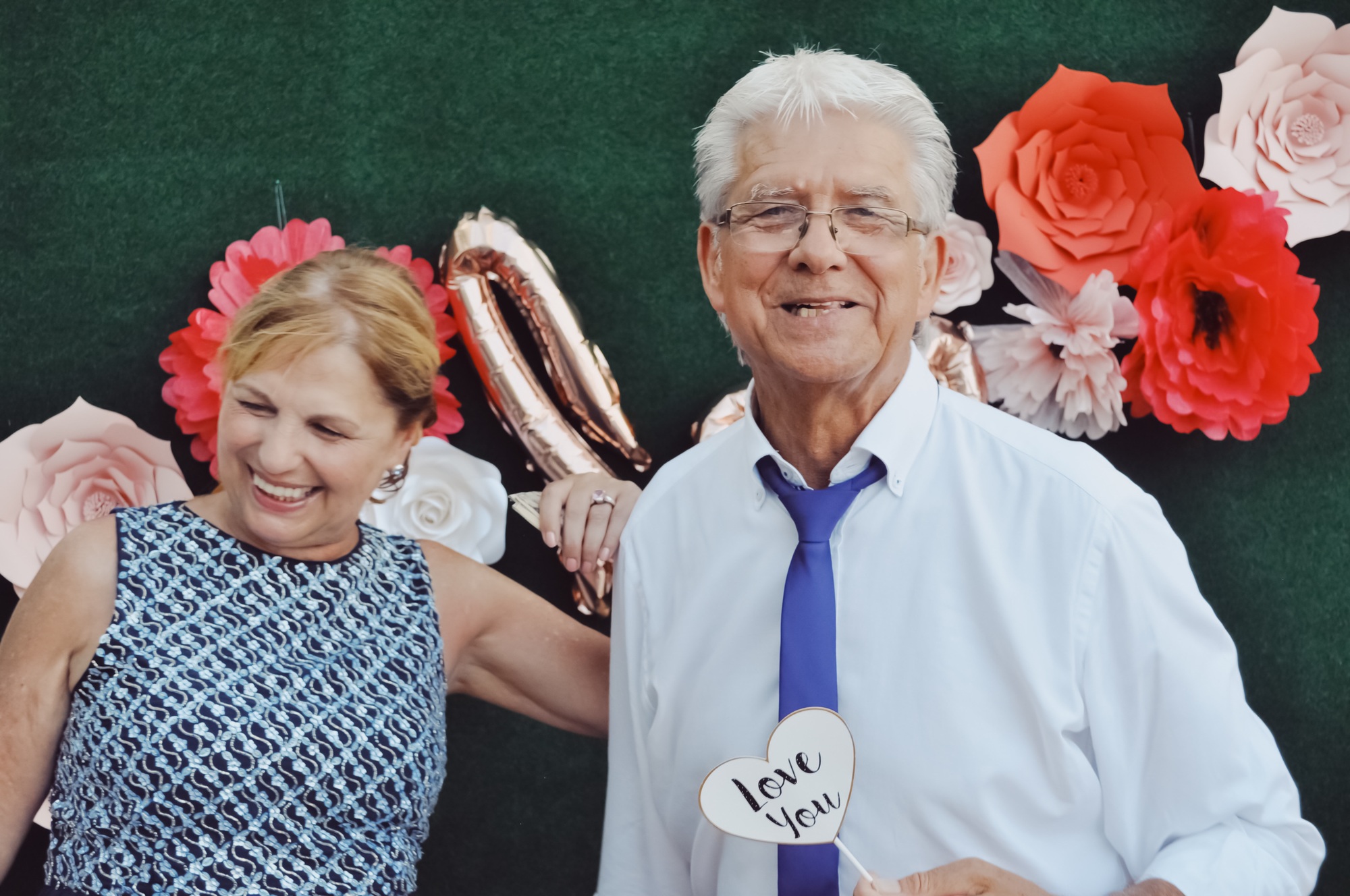 Senior couple having fun in photo booth