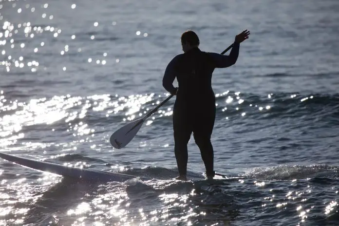 Silhouette of a woman on stand up paddle board