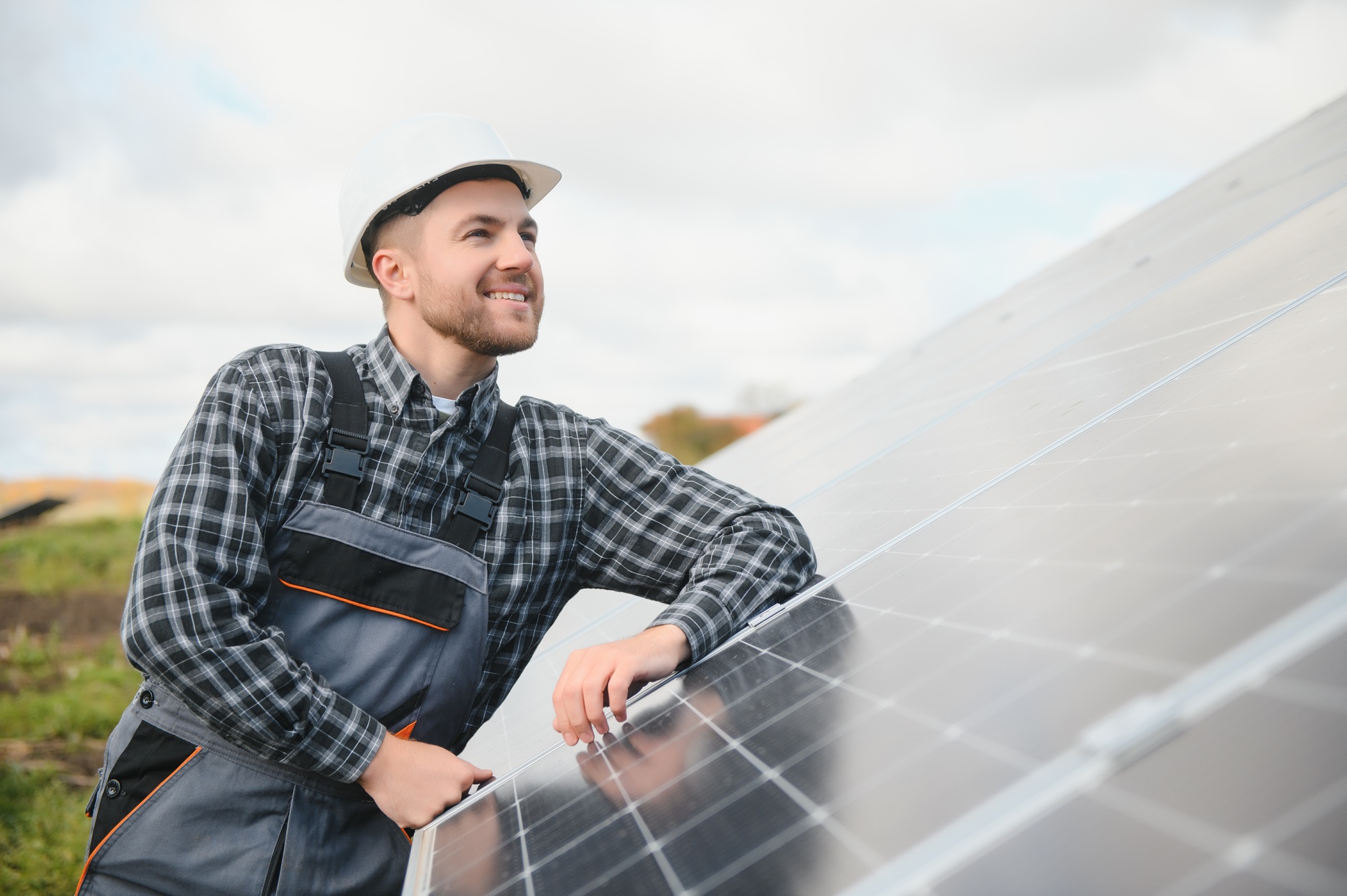 Solar power plant worker checks the condition of the panels