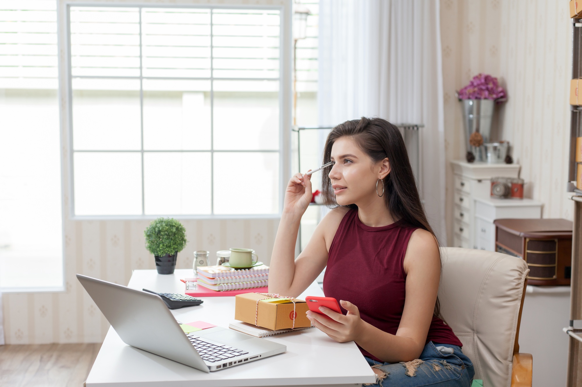 Startup small business owner working at house. Young asian woman happy with the sale of goods online