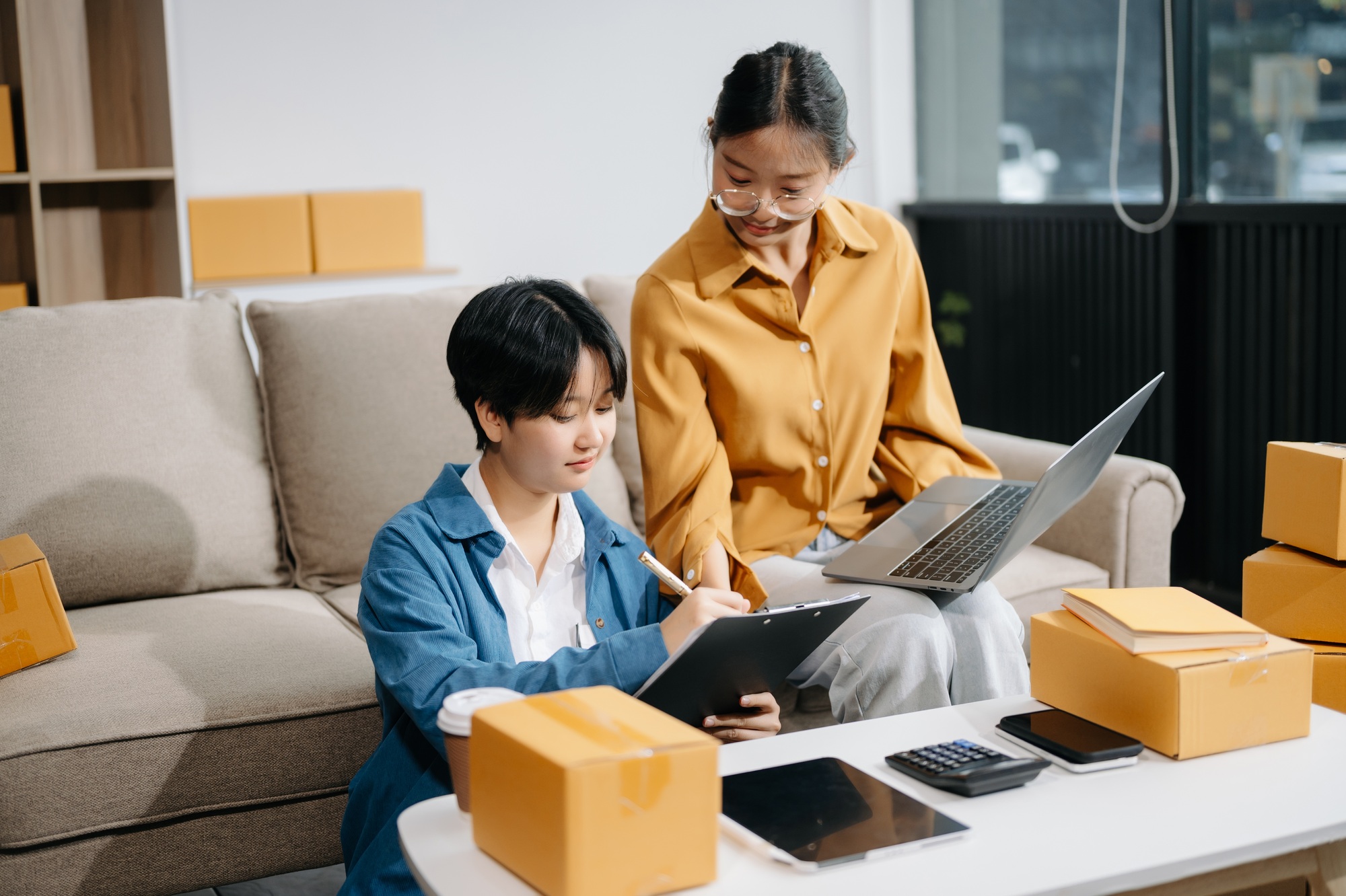 Startup small business SME, Entrepreneur owner two woman using smartphone or tablet taking receive