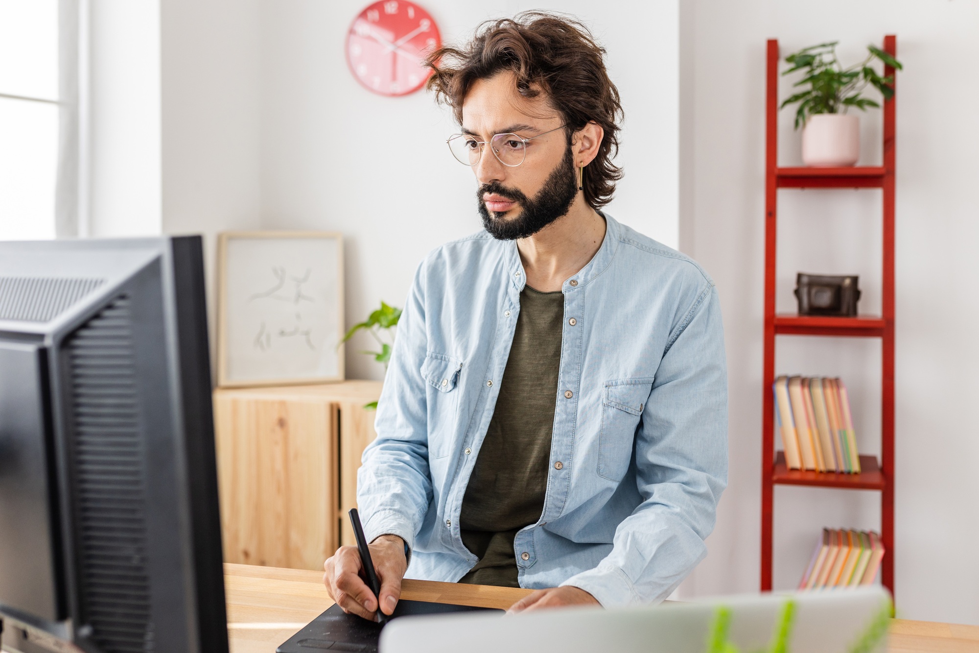 Successful young man freelancer creative designer working at home studio