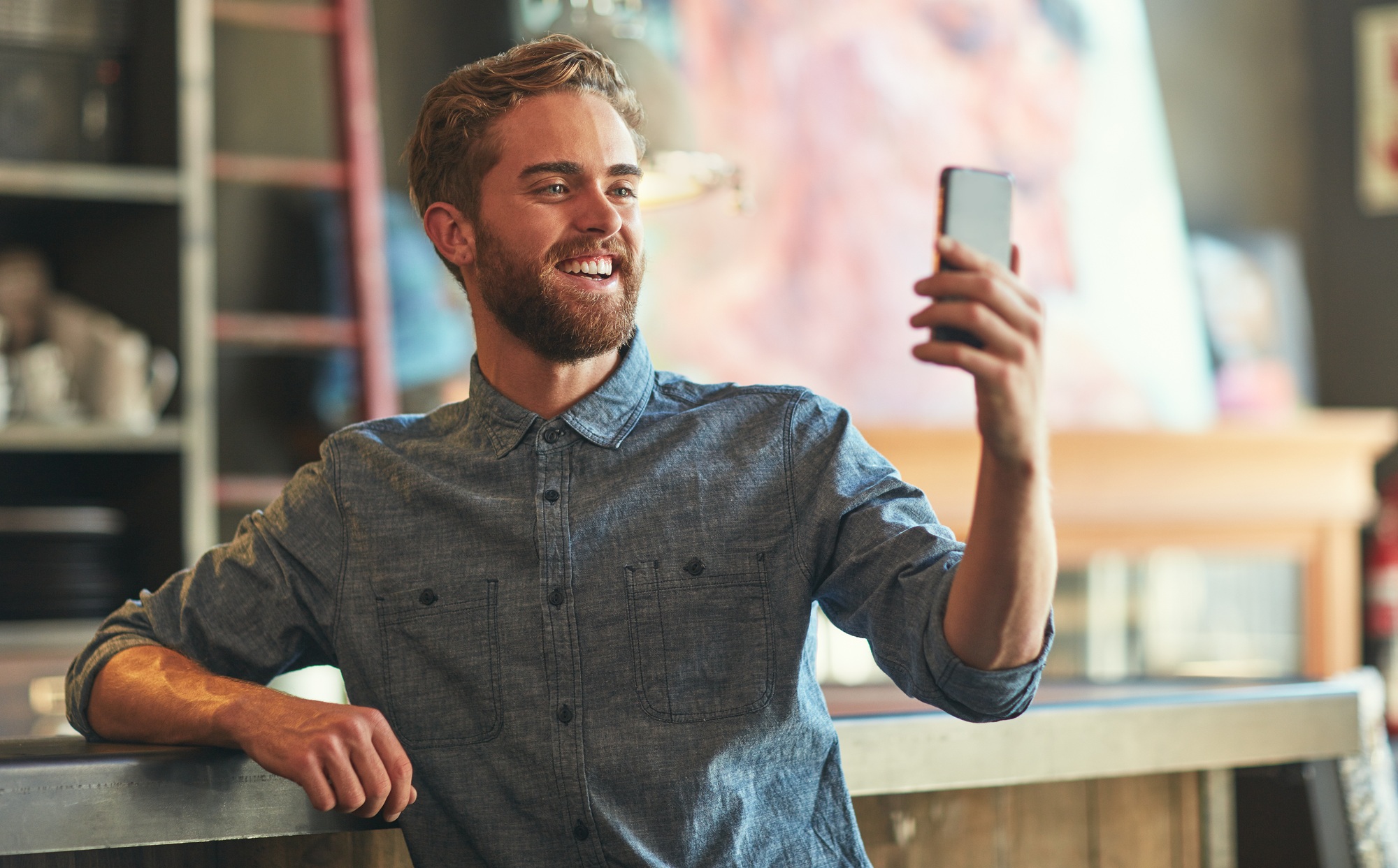 Taking a picture of his brand new coffee shop