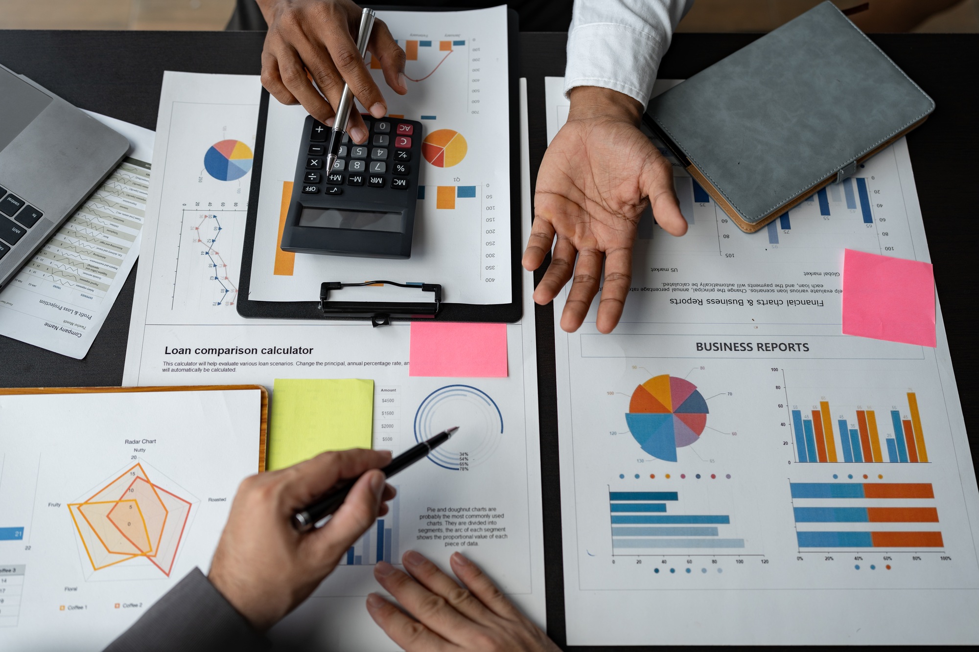 Team of business people analyzing, discussing, calculating earnings from earnings charts and graphs