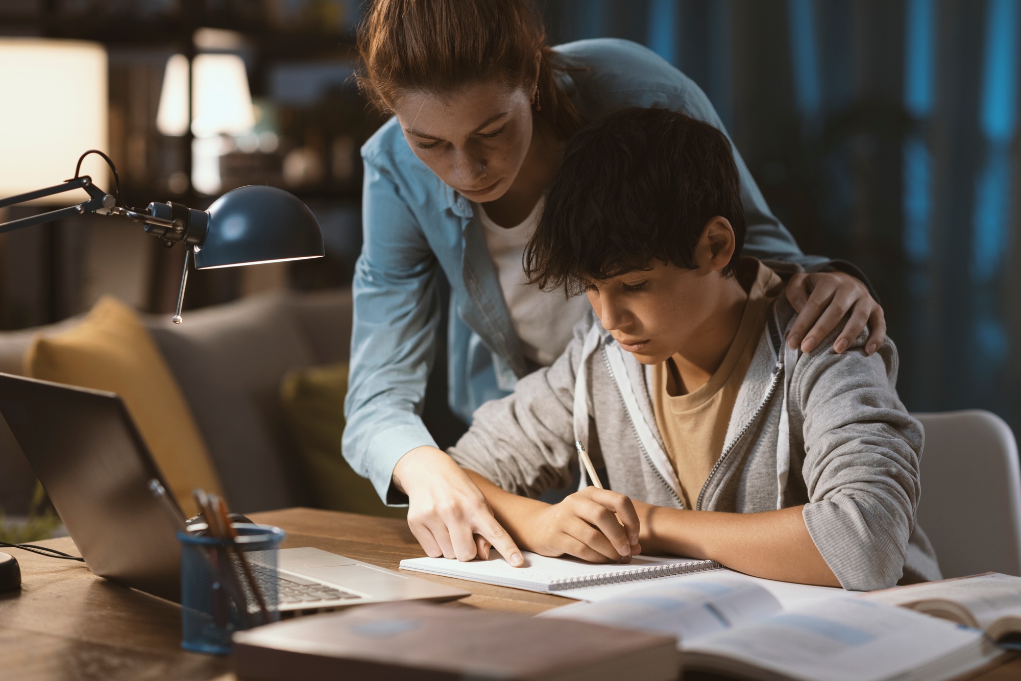 Tutor helping a student with his homework