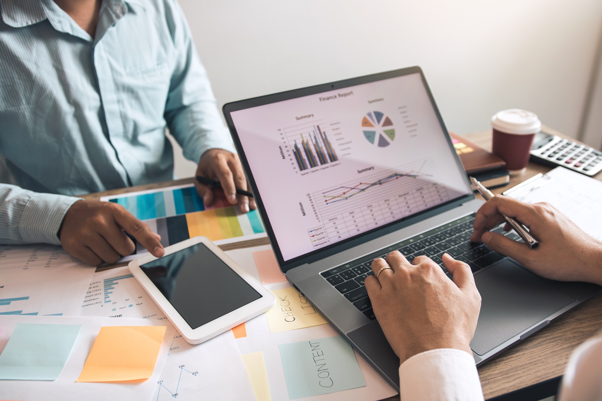 Two business partnership coworkers discussing a financial planning graph and company during a budget