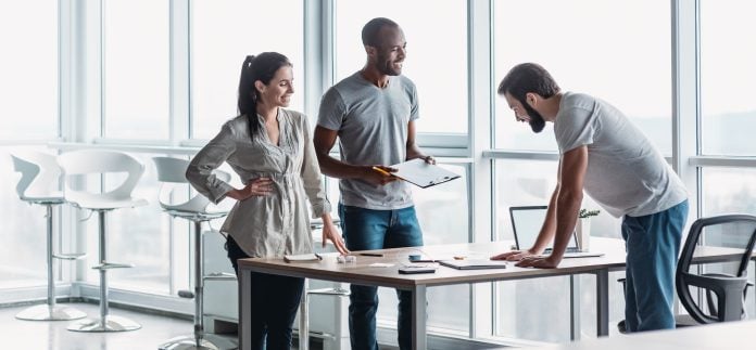 Website header of Young professional team discussing business plan in the office
