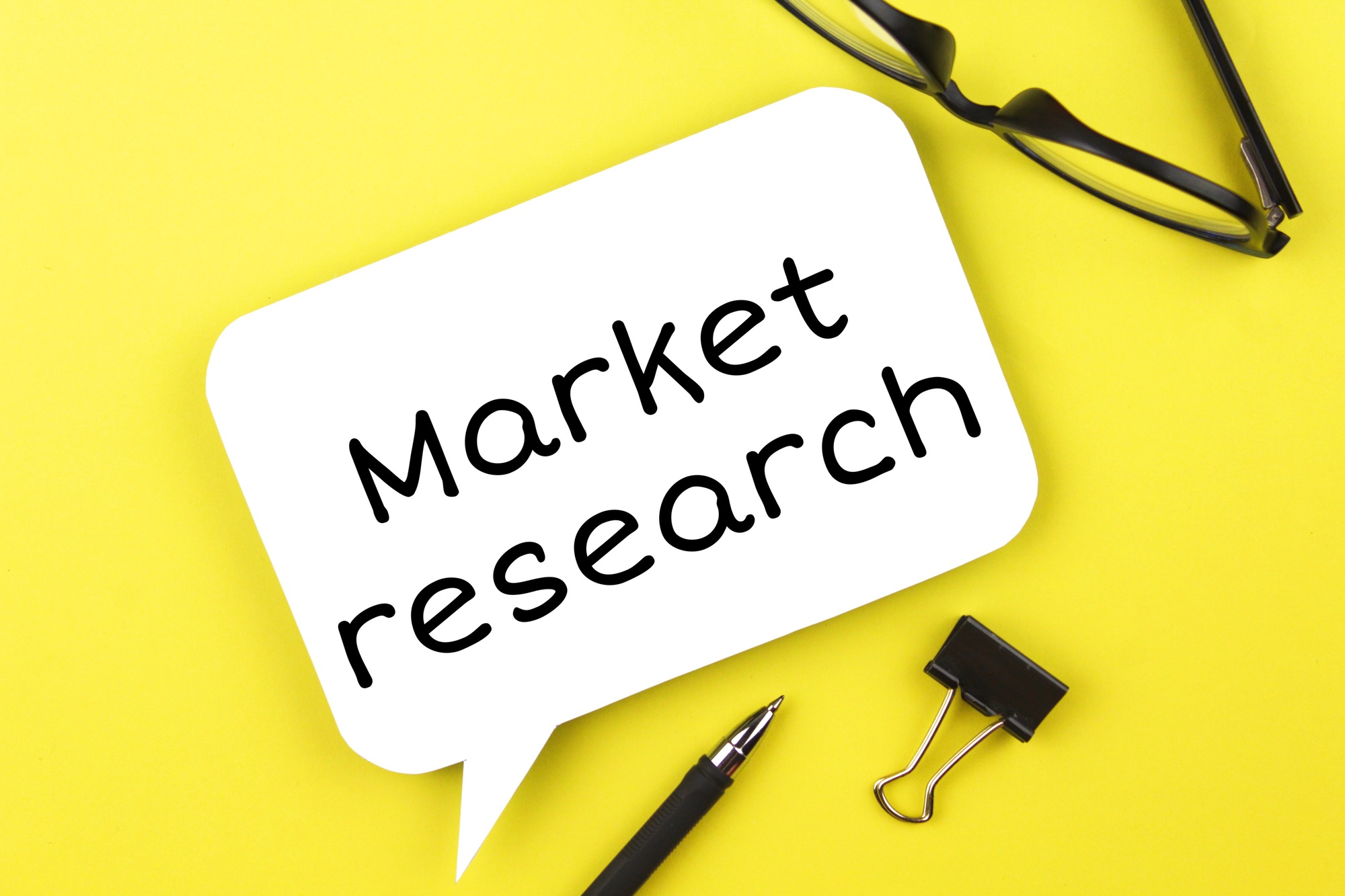 White paper speech bubble with inscription market research