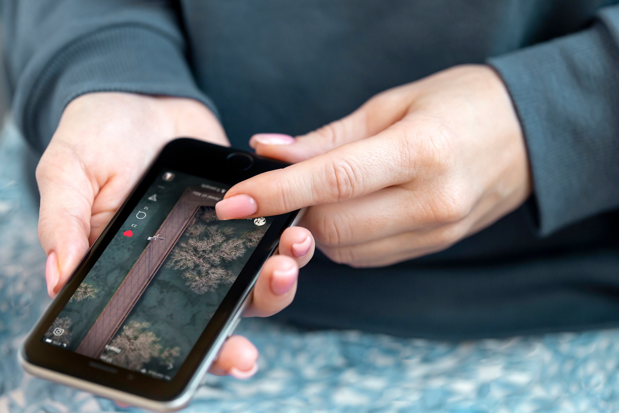 Woman checking daily instagram reels, social media is part of our lives. Female hands only in frame.