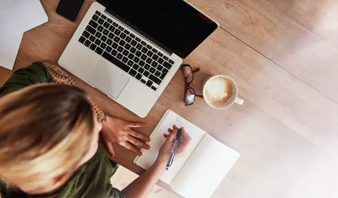 Woman making to do list on diary