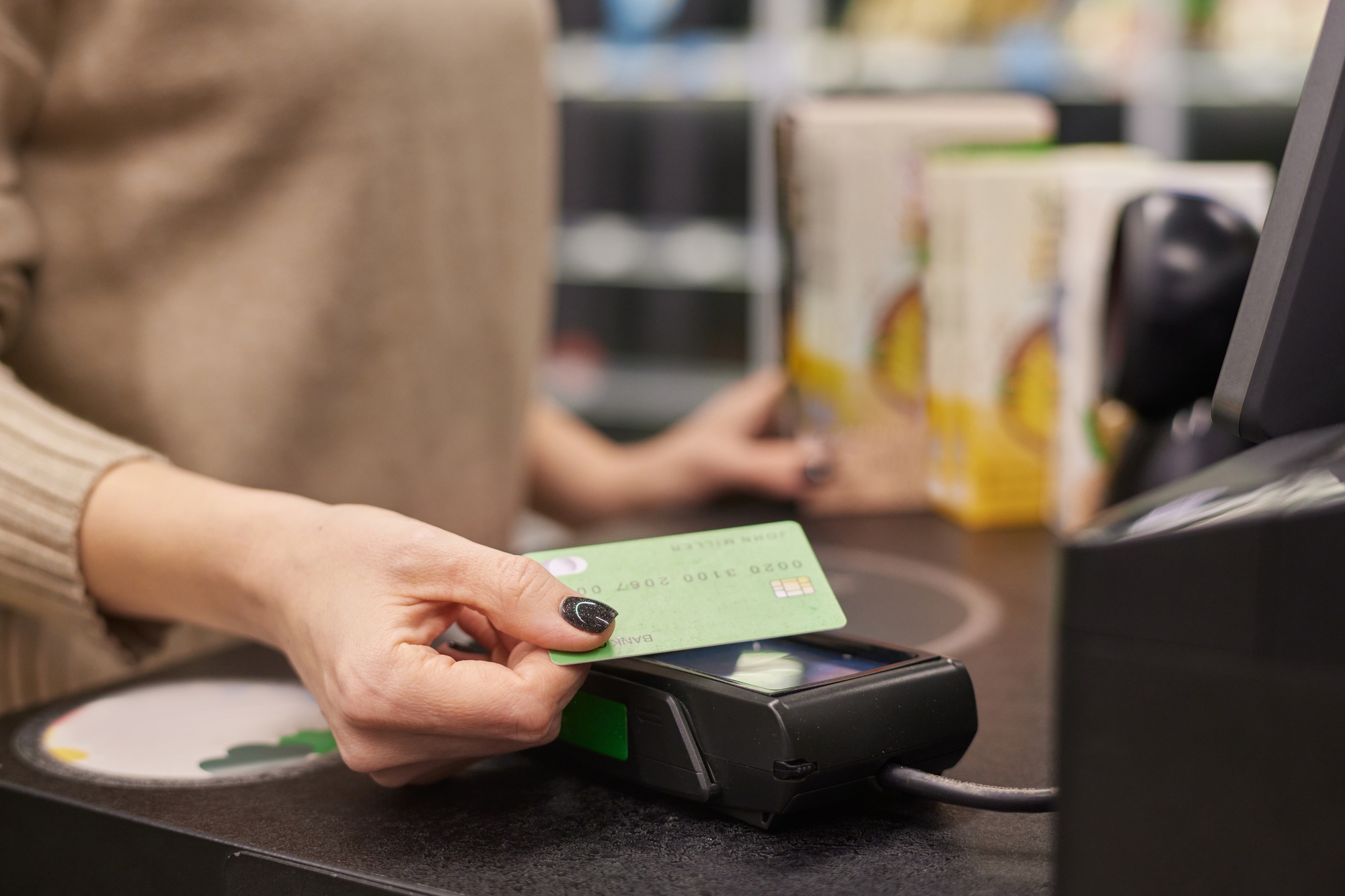 Woman paying in grocery store