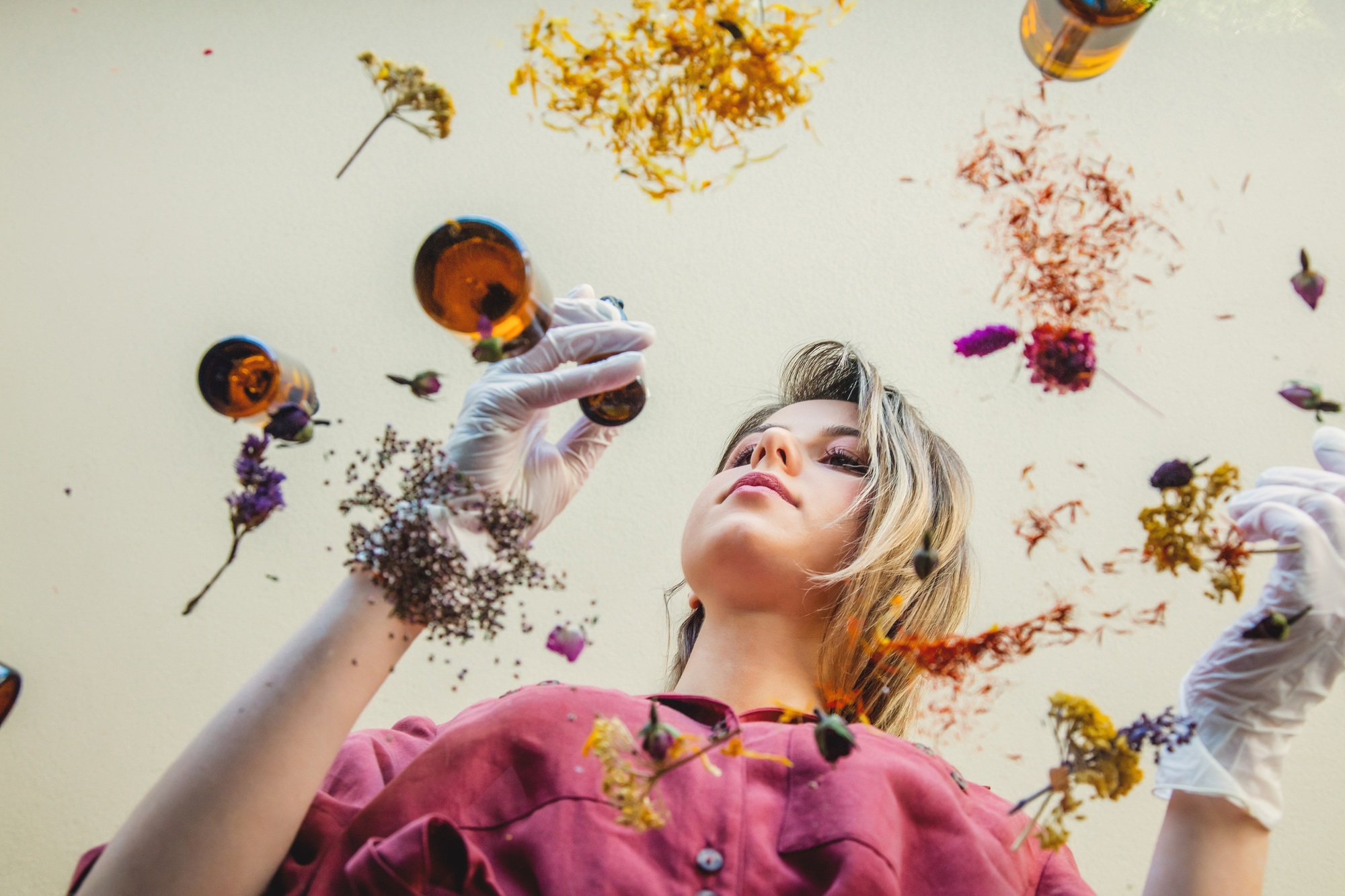 woman perfumer preparing herbs and flowers for make a perfume.
