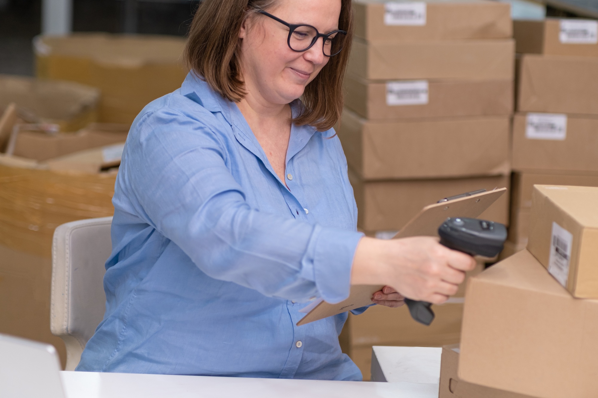 woman runs online shop, managing and tracking orders while also packaging and shipping products