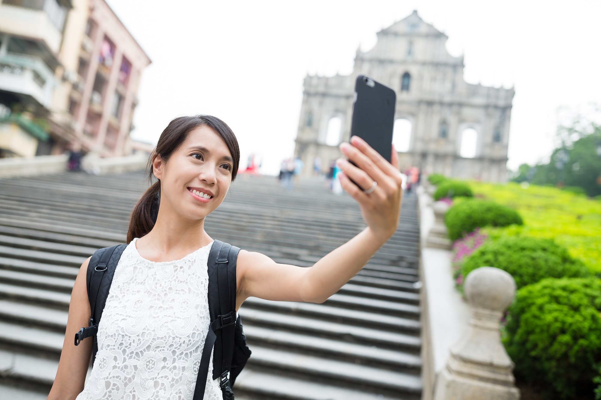 Woman taking image by mobile phone