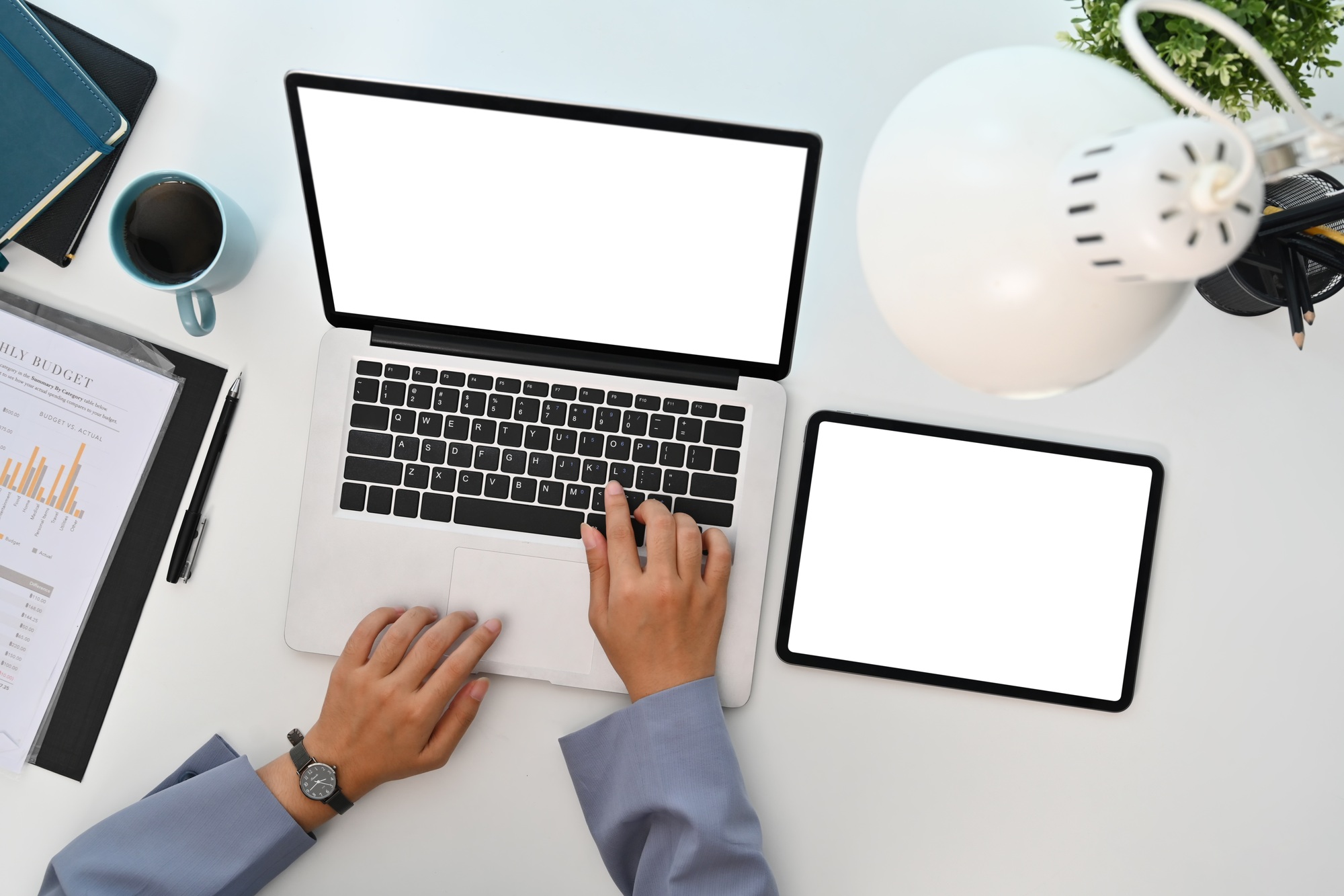 Woman using laptop computer at modern workplace. Empty displays for your advertising text