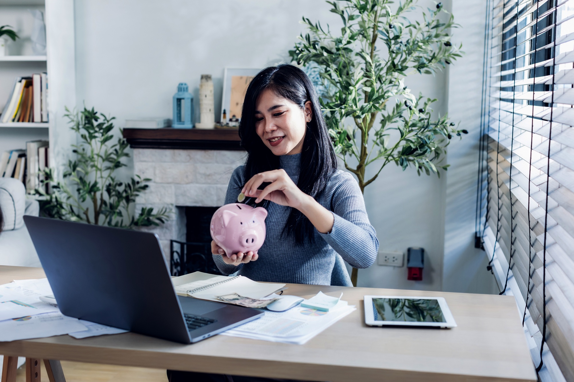woman working from home concept saving money for finance accounting.