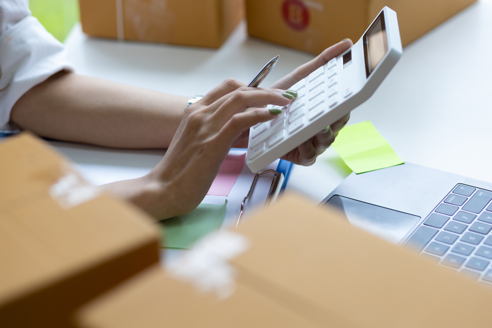 Women Small Startup Business Owners Calculate Costs and Shipping Costs