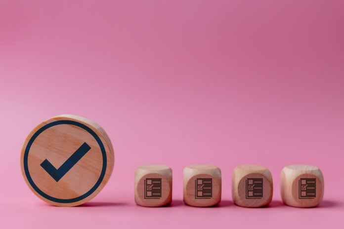 Wooden blocks with check mark symbol Checklist business target marketing quality management