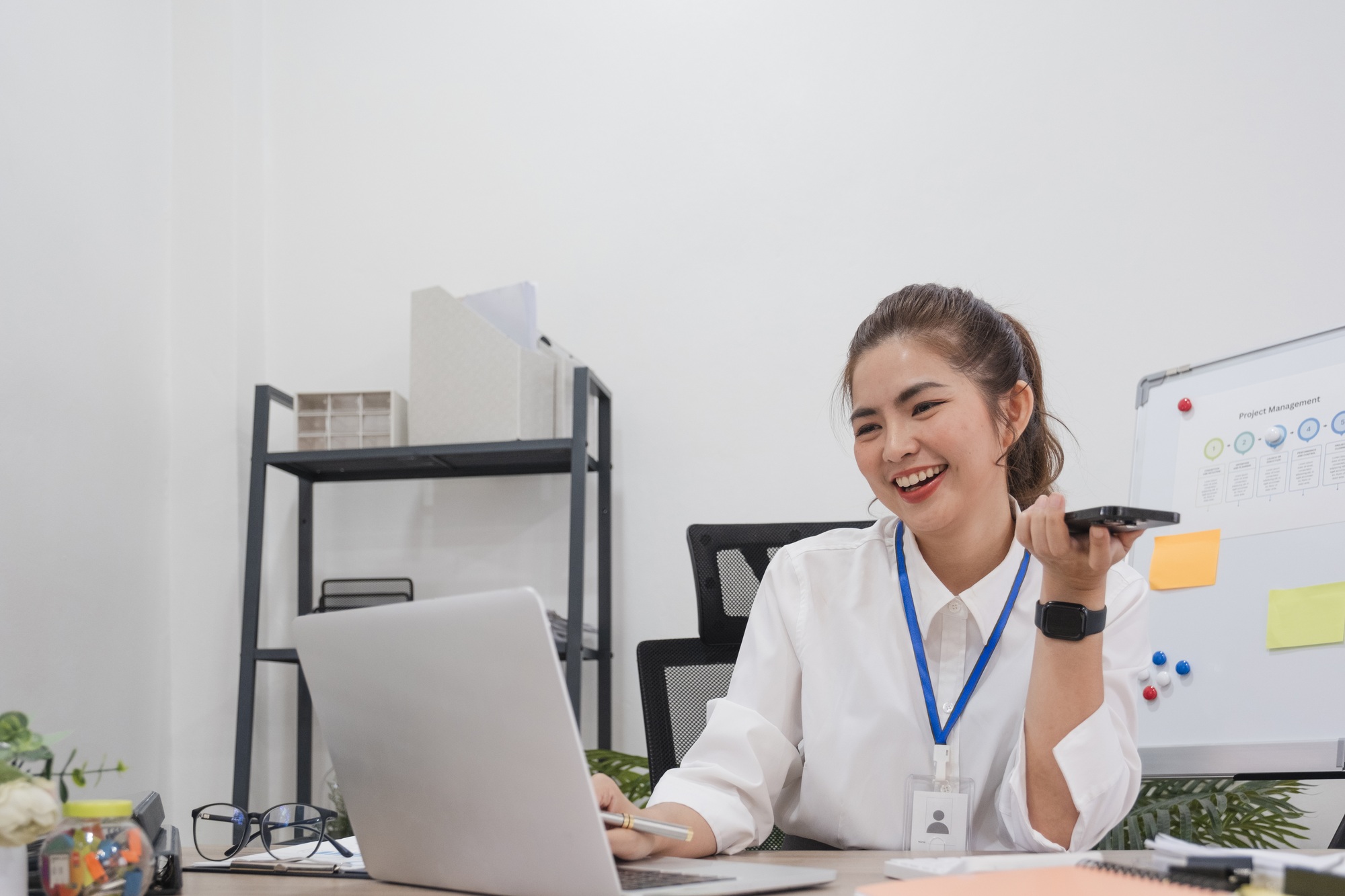 Young businesswoman uses the phone to talk with customers in business planning, business management.