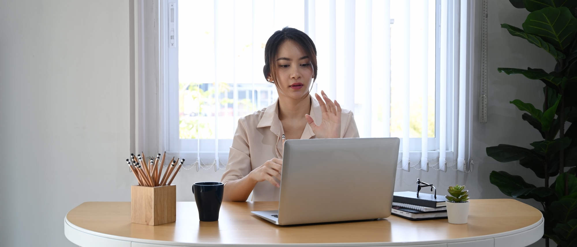 Young businesswoman using laptop computer virtual video conference with her business partner.