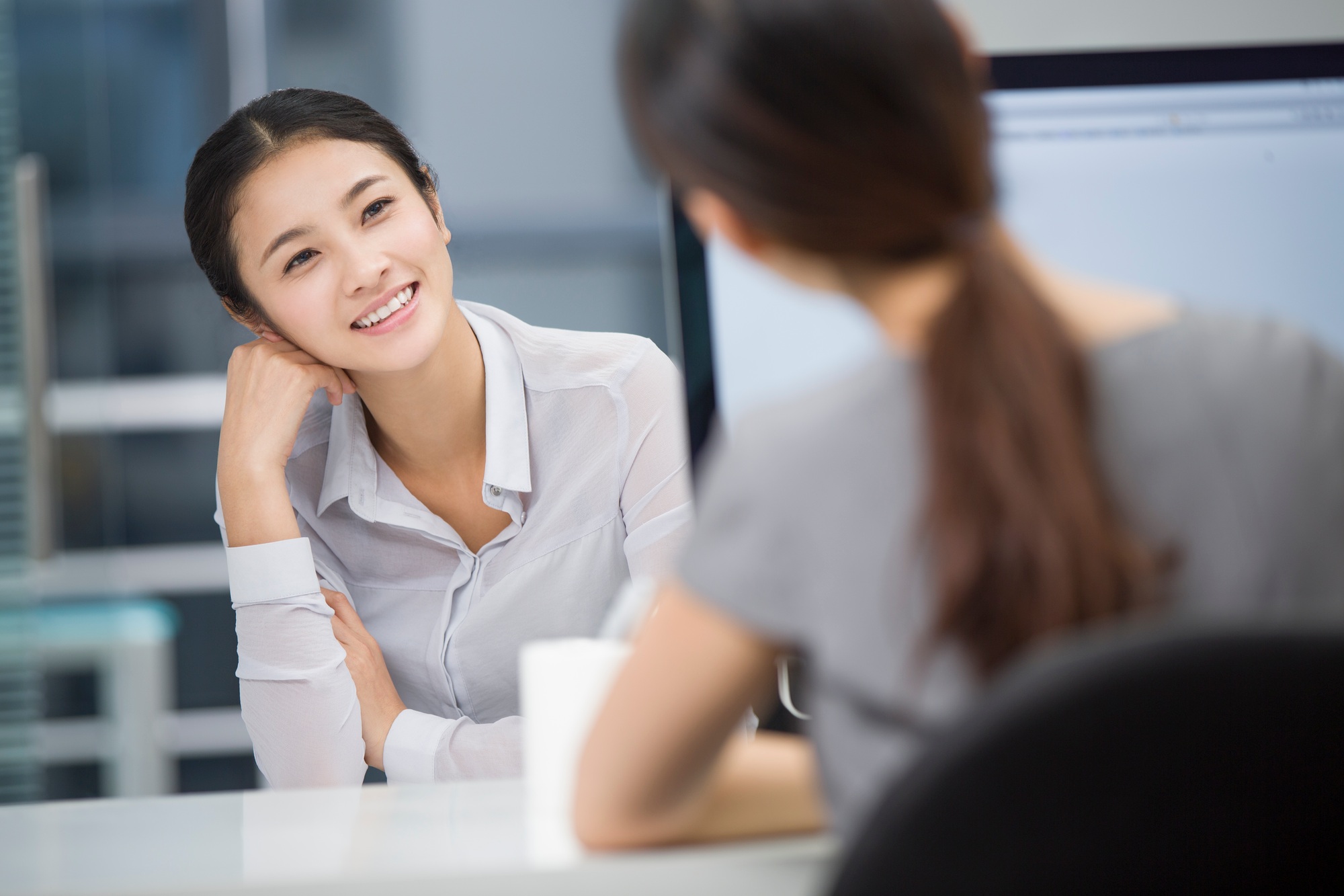 Young businesswomen talking in office