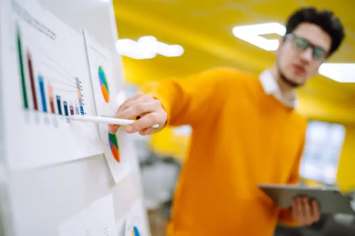 Young man leader, presenter, make a business presentation at a conference in the office.