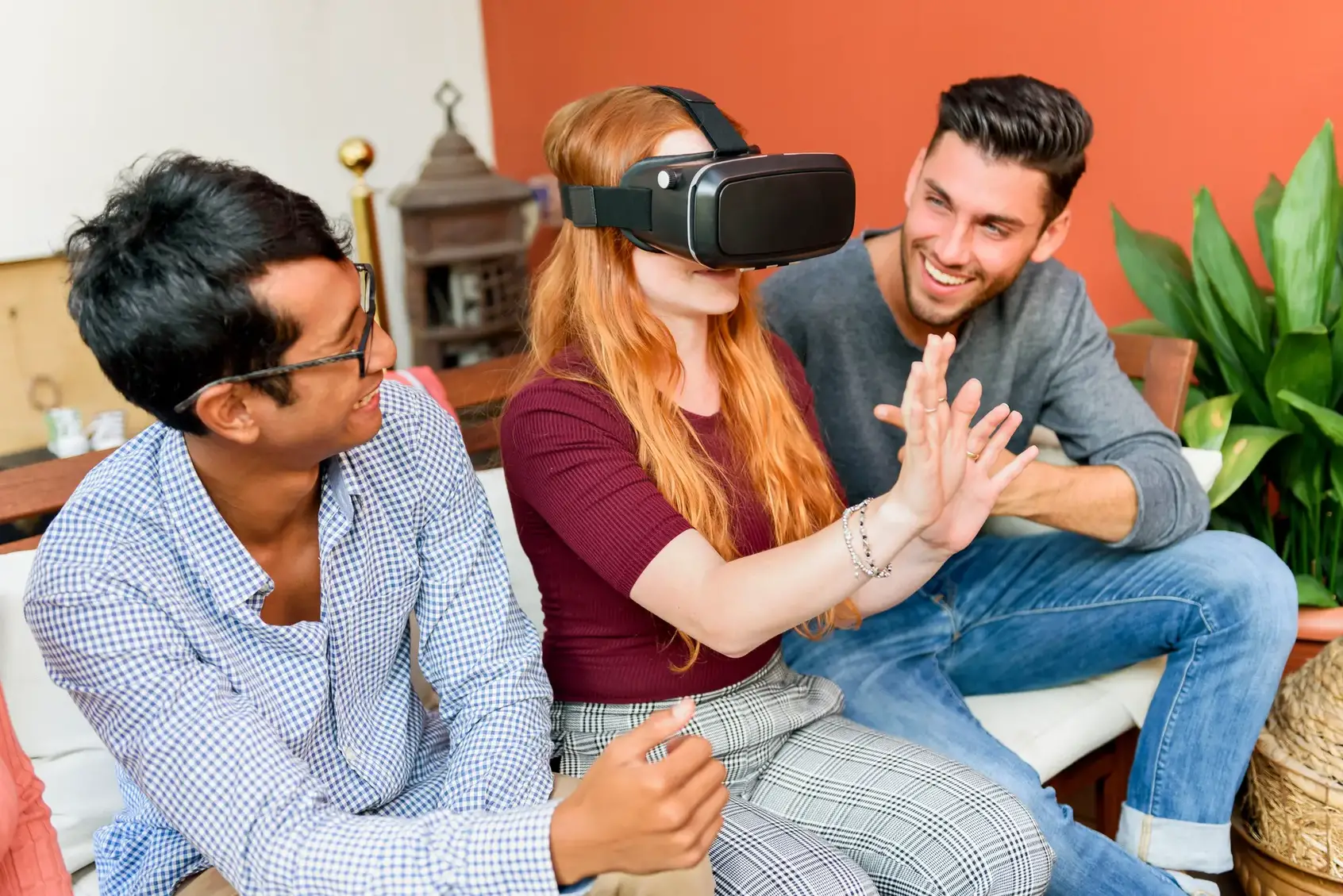 Young woman exploring virtual reality with friends