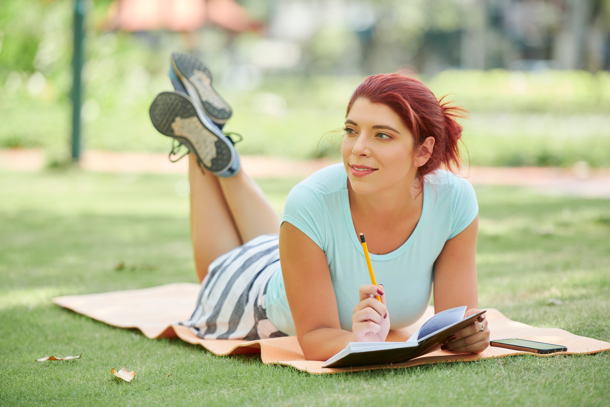 Young woman filling bullet journal