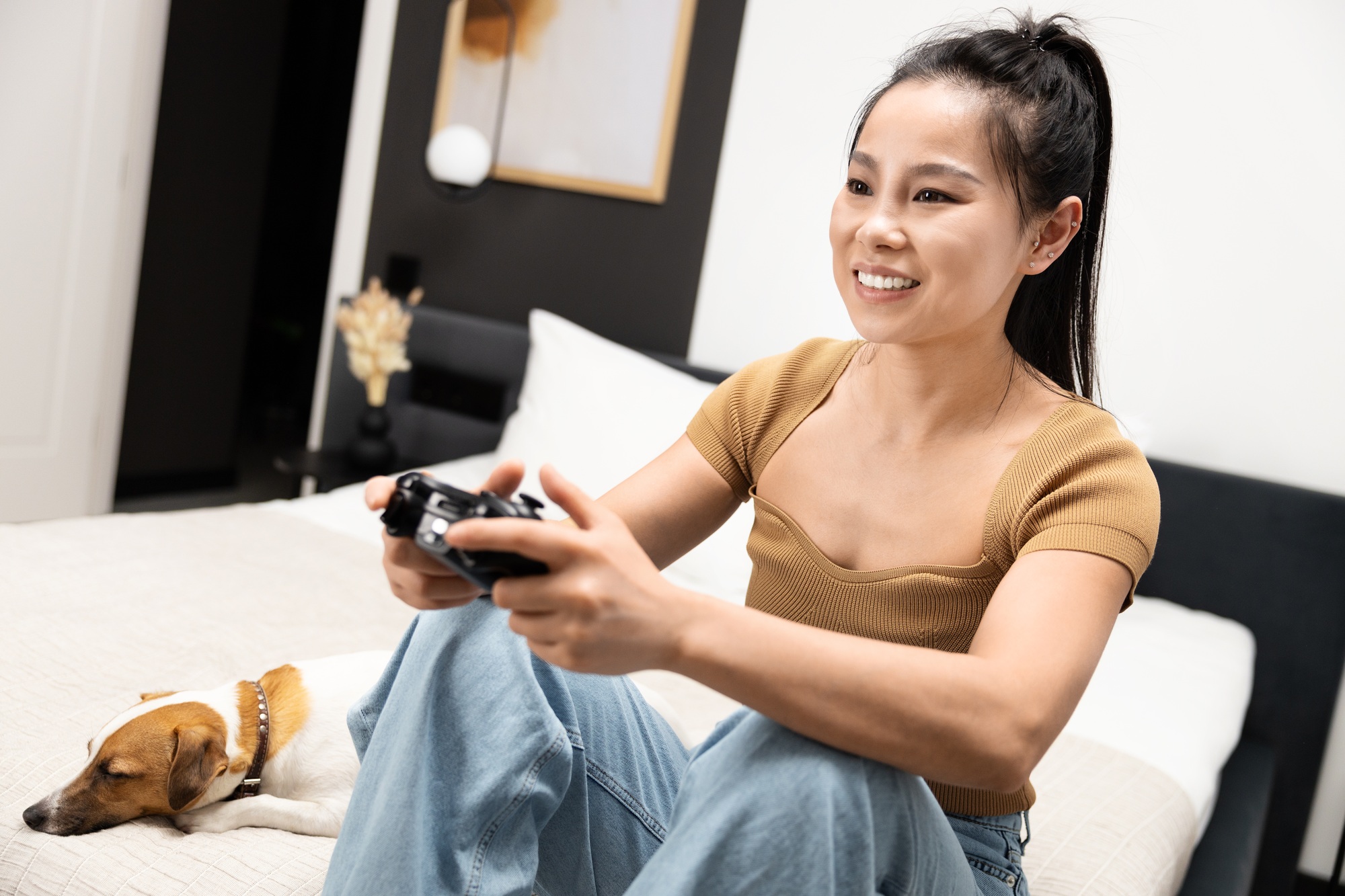 Young Woman Playing Video Games with Pet Dog Relaxing