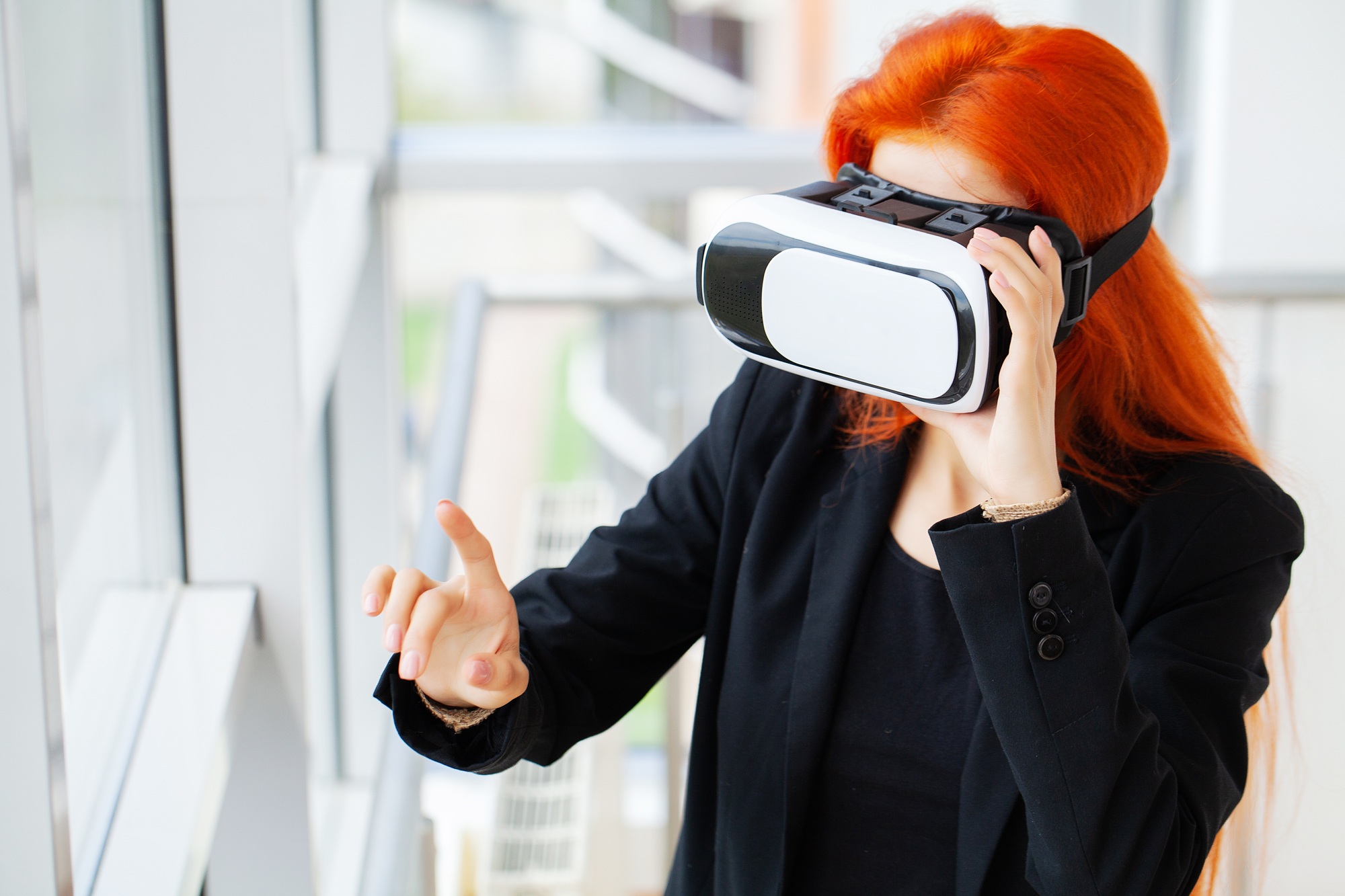 Young woman using virtual reality headset at technology exhibition