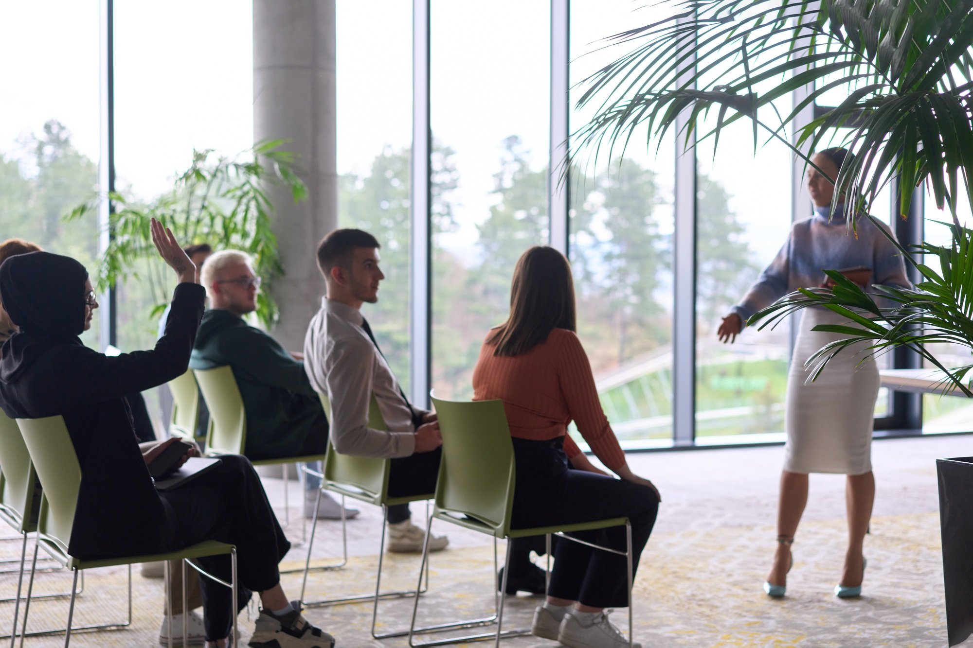 A businesswoman leader guiding a meeting with her colleagues, discussing business challenges