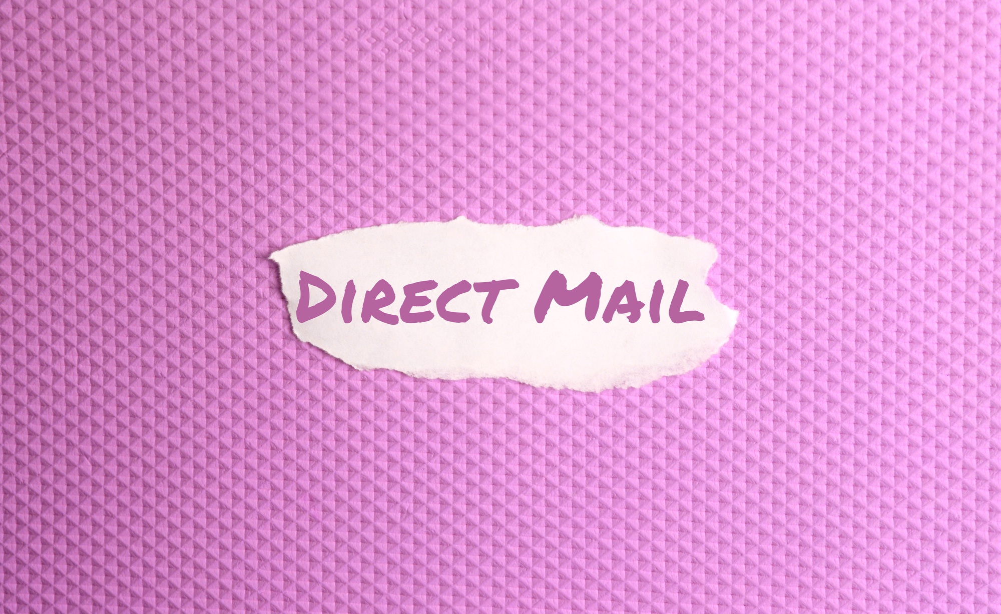 a torn paper written with inscription direct mail on a pink background