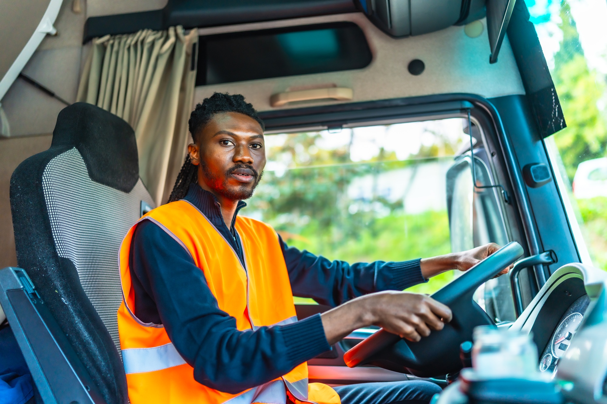 African young worker driving a distribution lorry