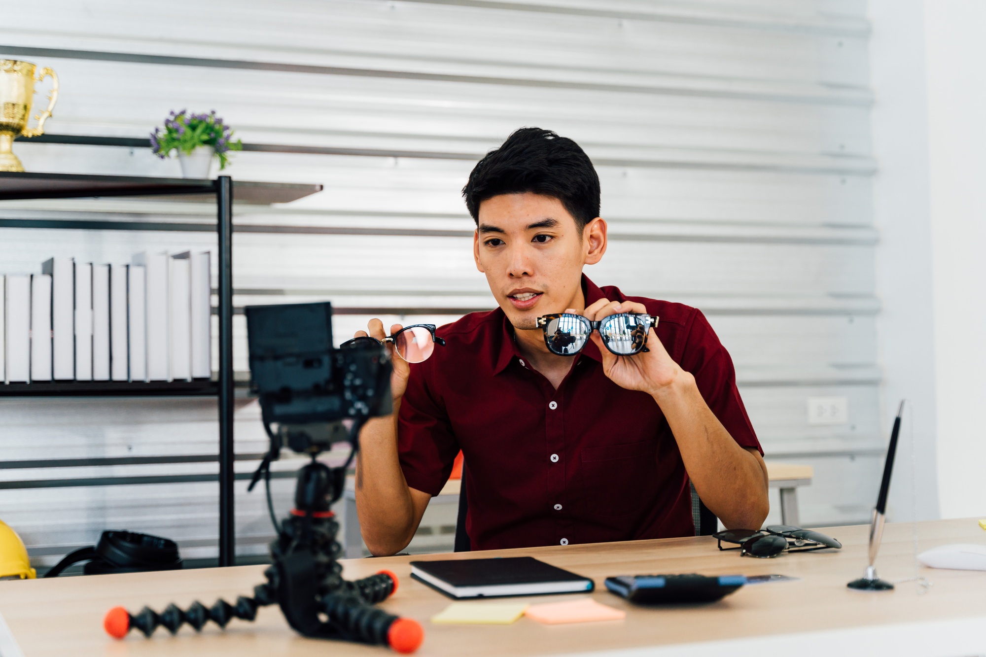 Asian blogger selling sun glasses recording video using camera