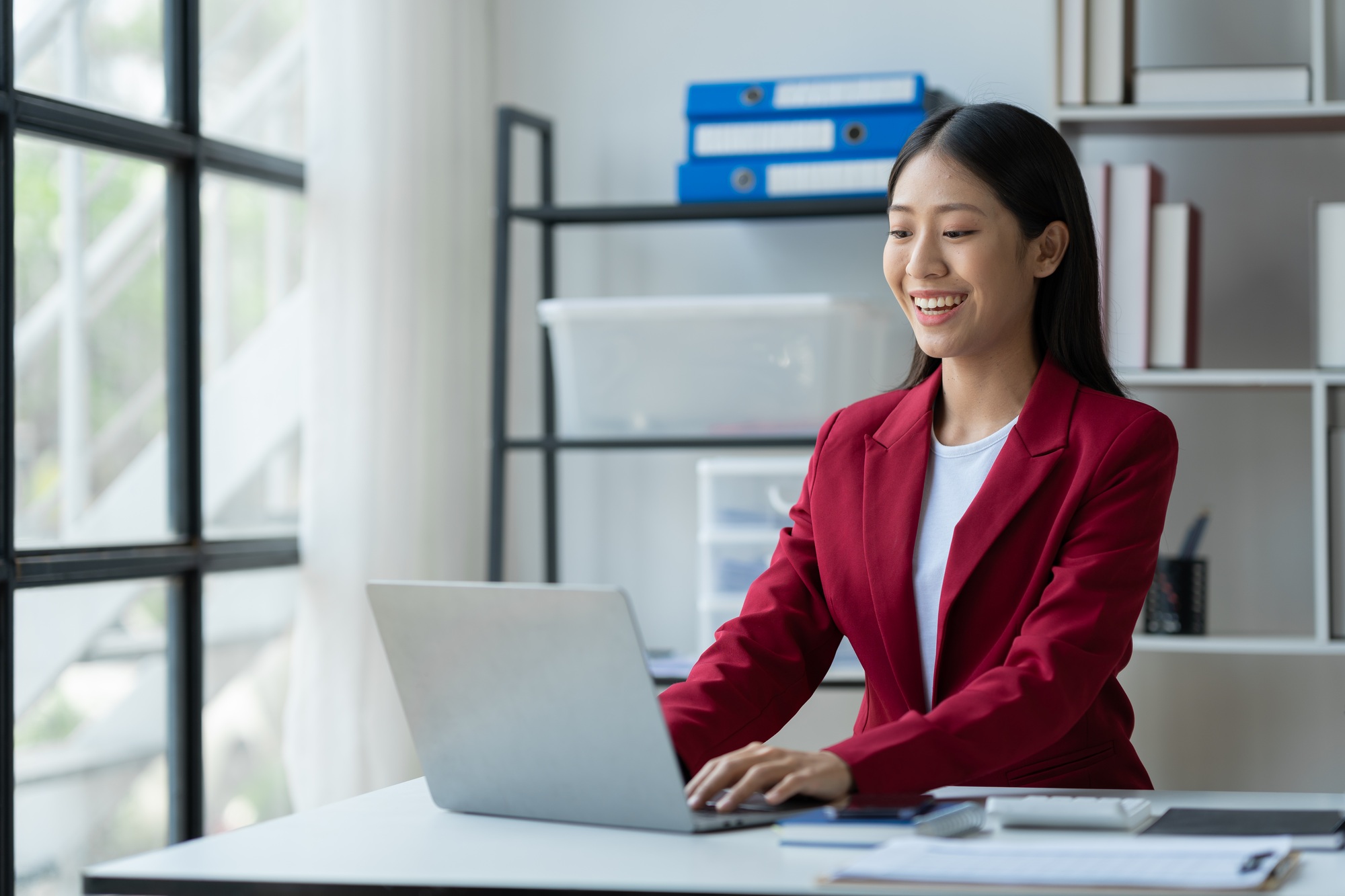 Asian businesswoman sitting and typing financial details marketing structure real estate business re