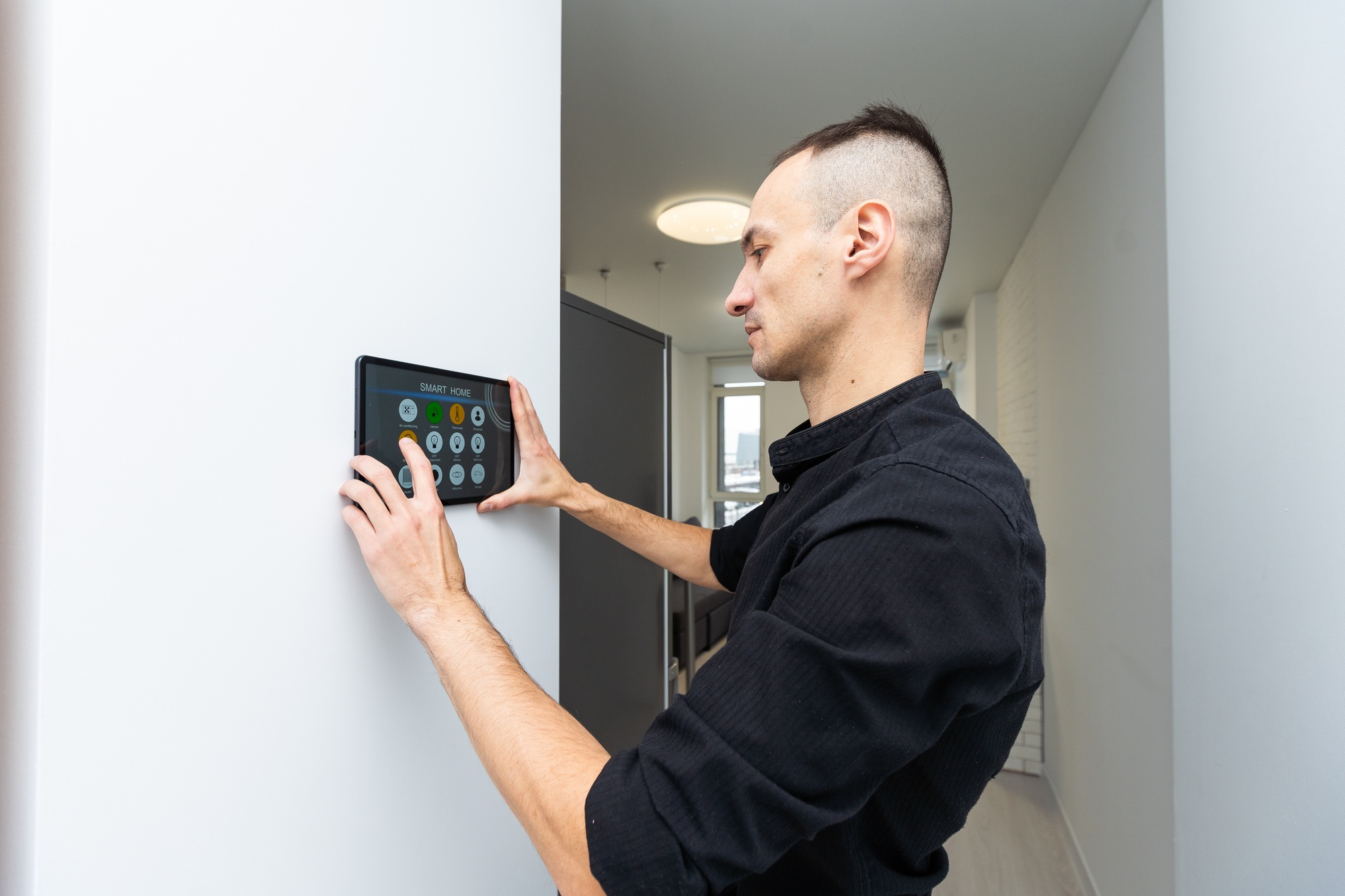 automation, internet of things and technology concept - man looking at tablet pc computer at smart