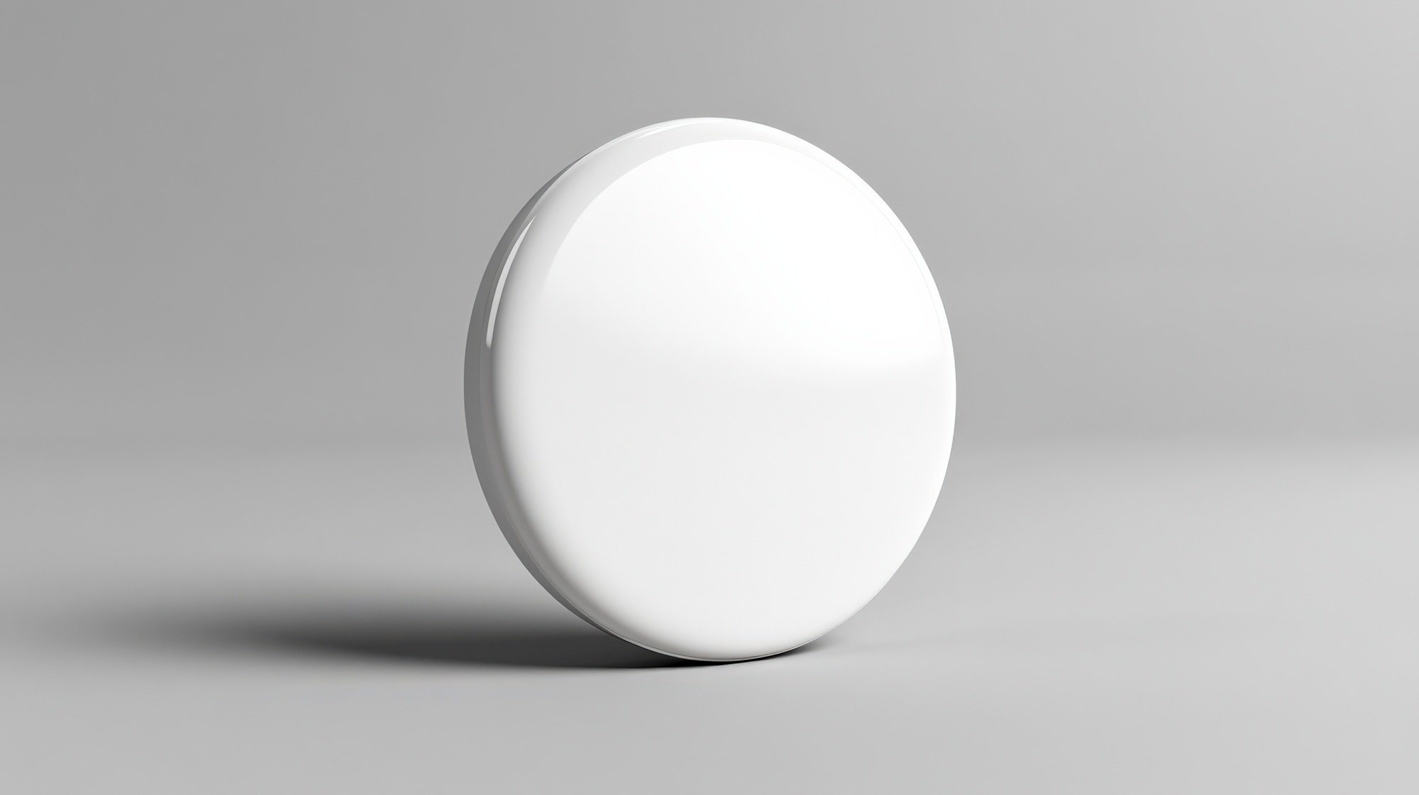 Blank round white badge on a gray background for design and branding presentations.