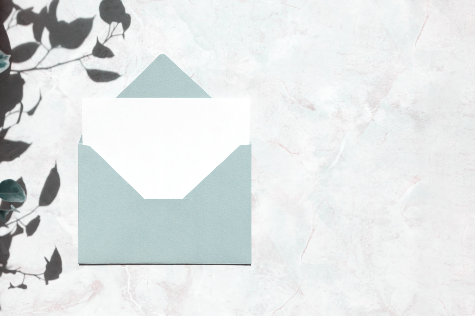 Blue mail envelope and blank white paper card for letter or postcard