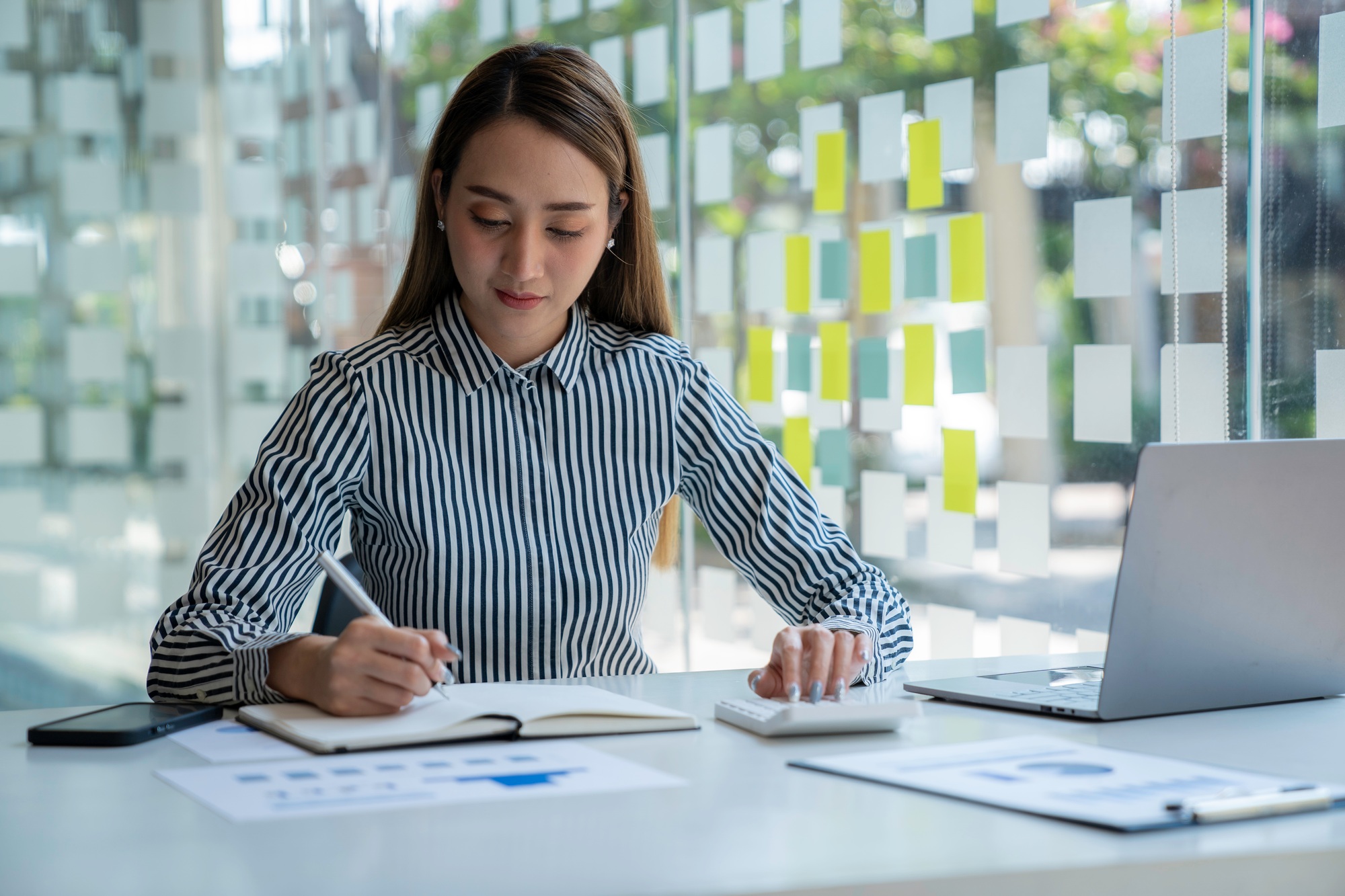 Bookkeeper accounting Concepts, Male use calculator, pen and computer laptop to monitor money saving