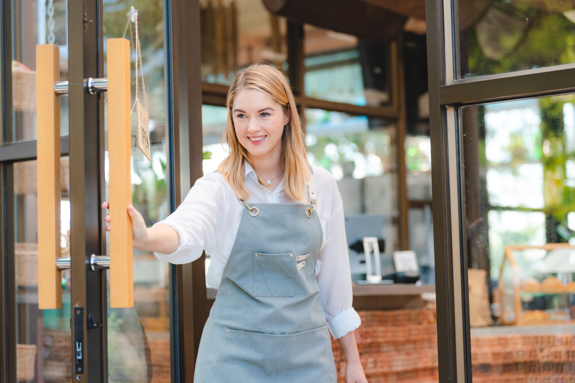 business cafes owner woman or barista worker wearing apron opening a coffee shop to start a business