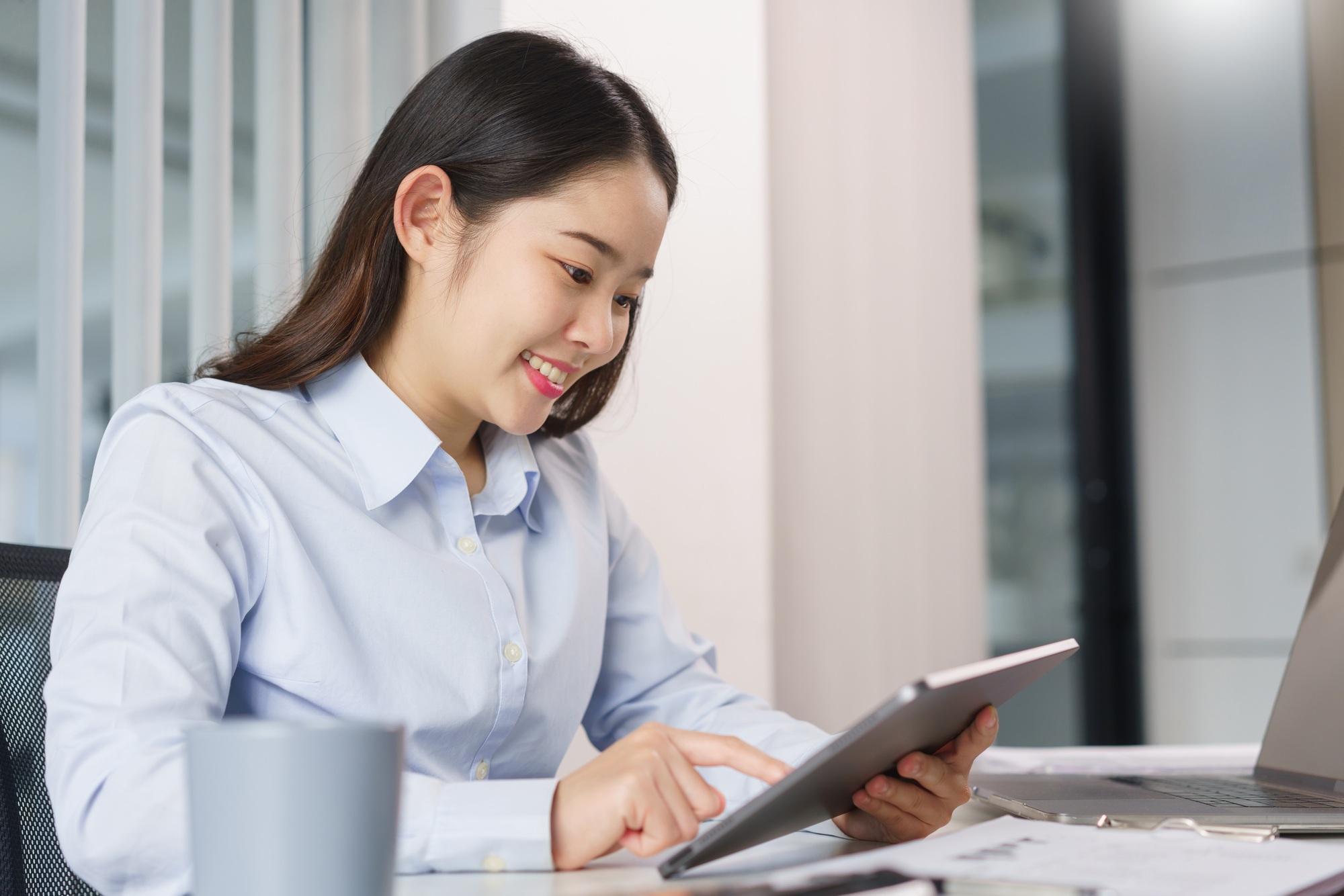 Business concept, Businesswoman researching and checking of marketing data on tablet in office.