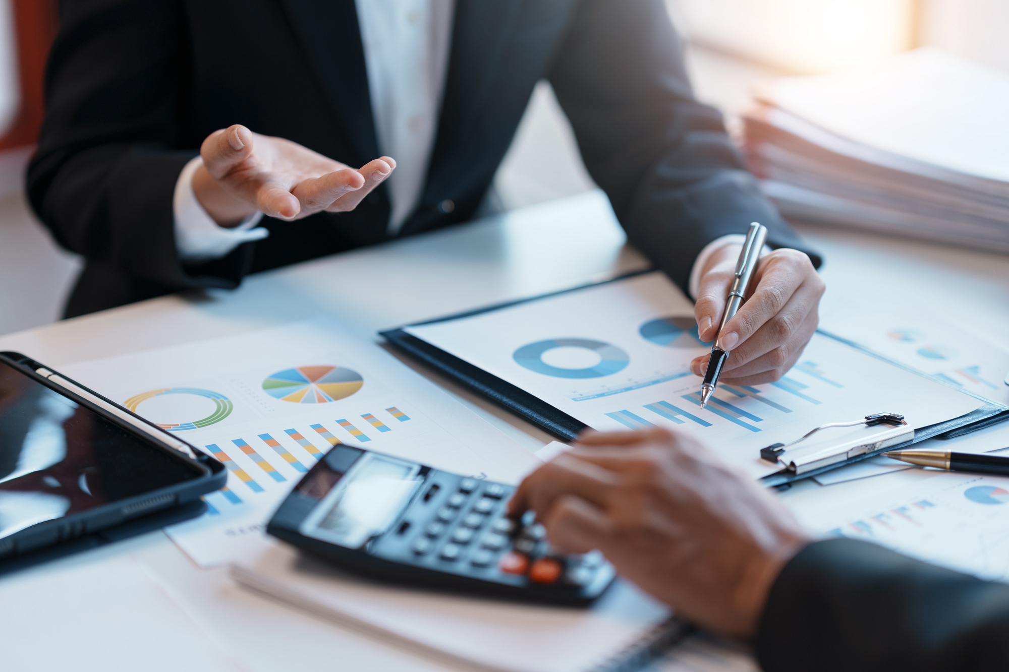 Business people meeting and calculating profit and loss The balance sheet for each quarter look at g