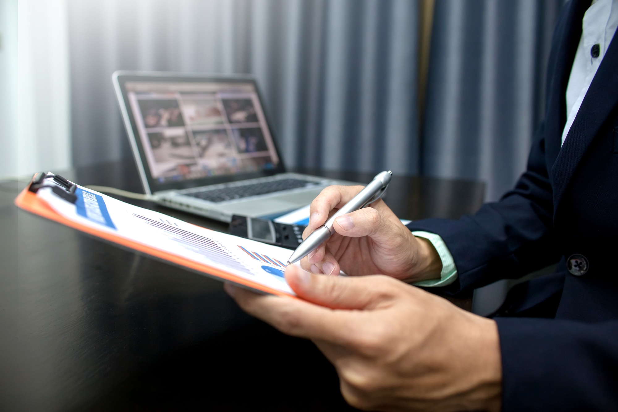 Businessman analyzing business information documents in the workplace.