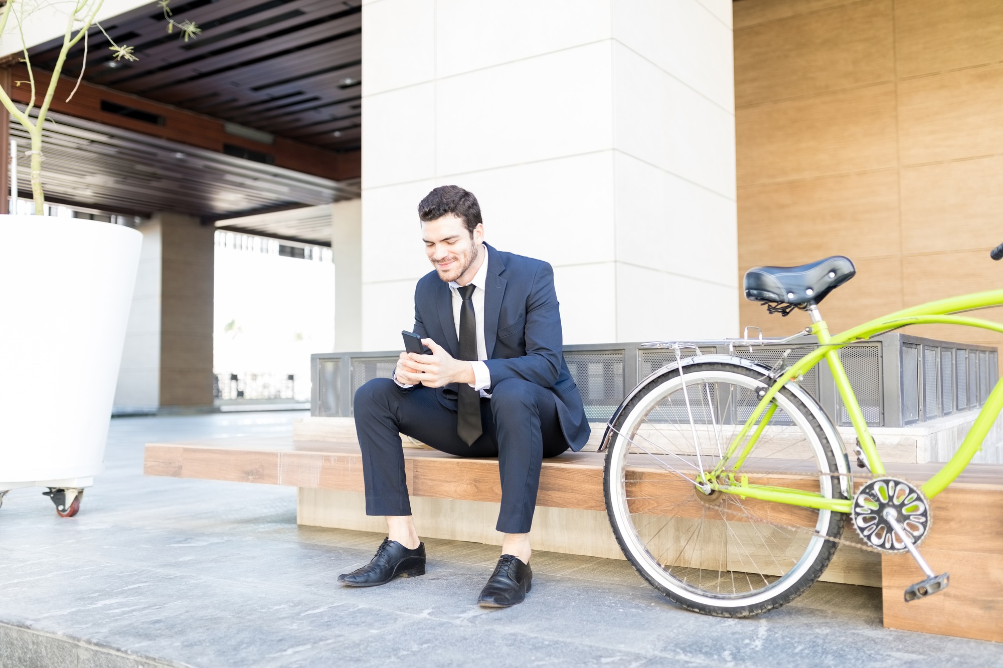 Businessman Checking E-Mail On Mobile Phone In City