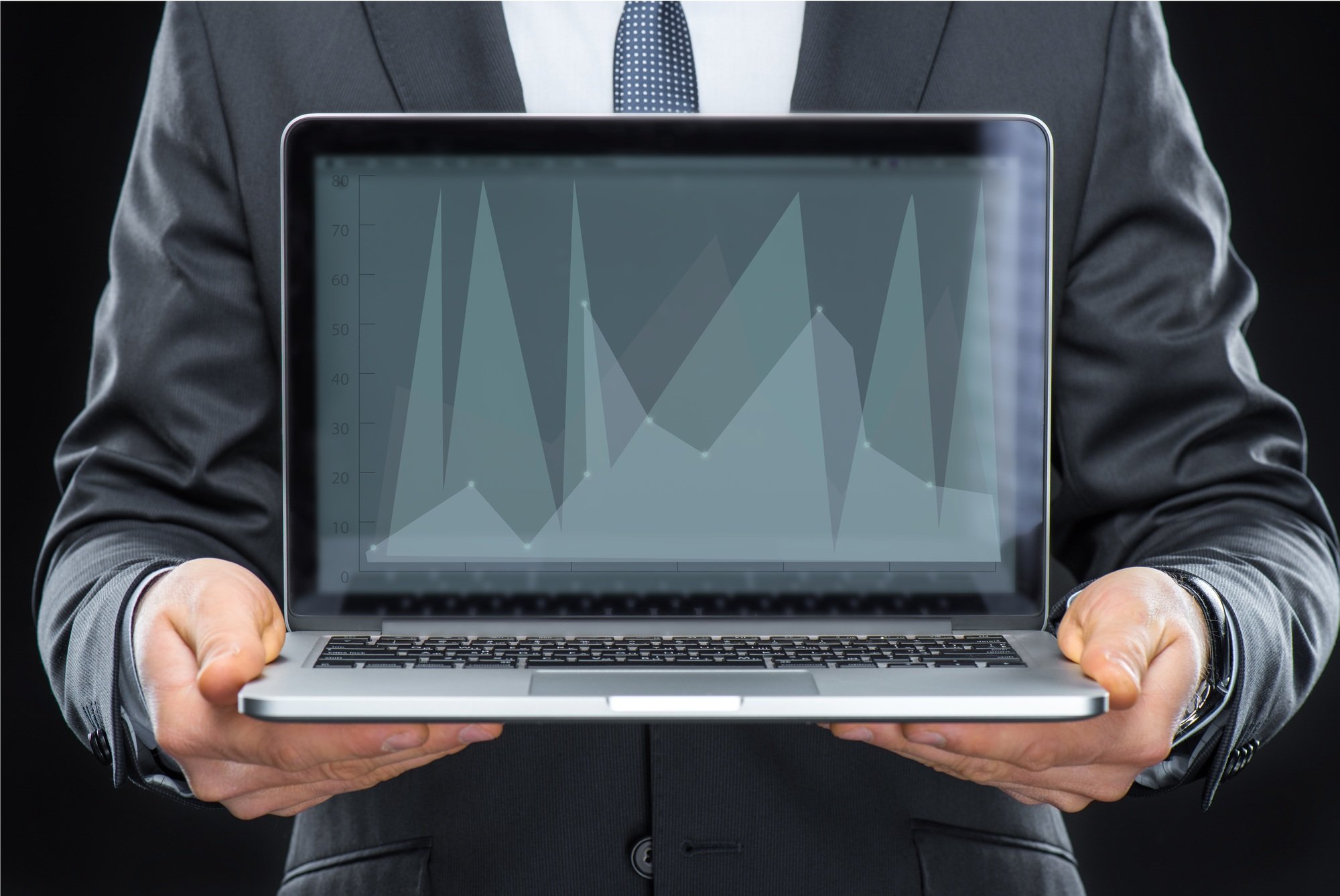 Businessman holding laptop computer with diagram on screen