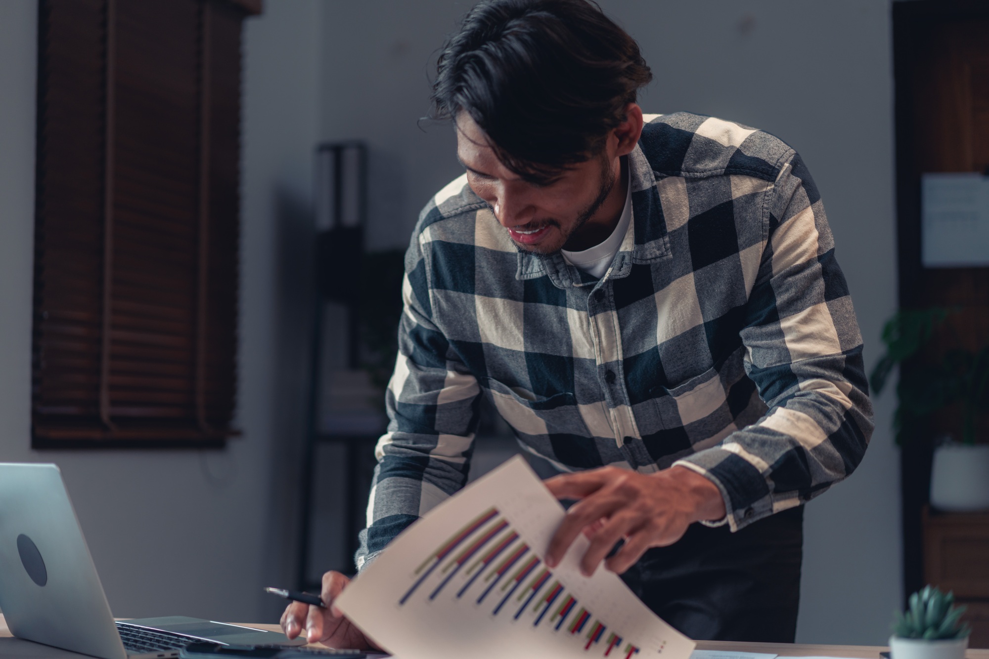 Businessman working to checking financial and accounting report of business project with calculator