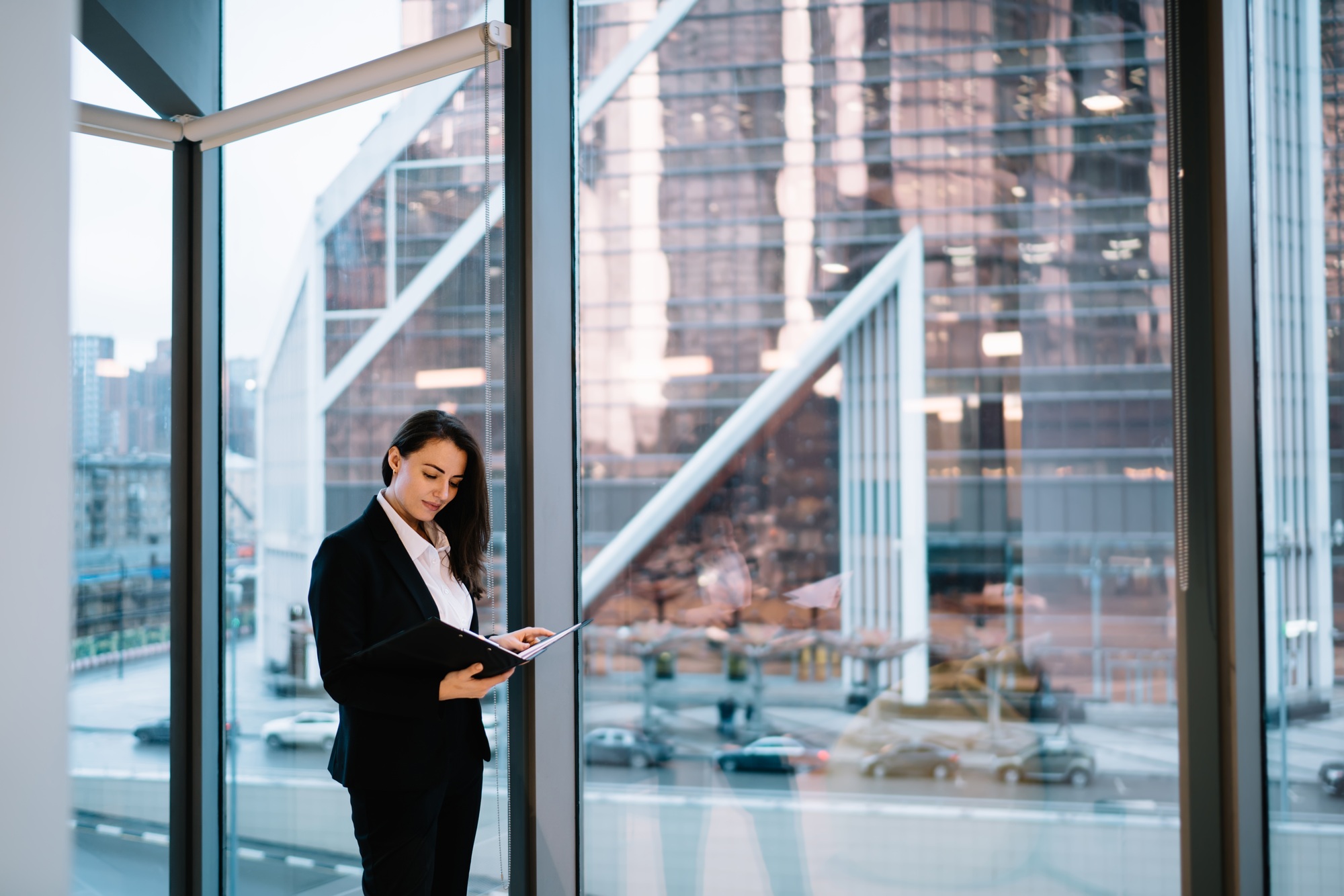 Businesswoman reading documents in office