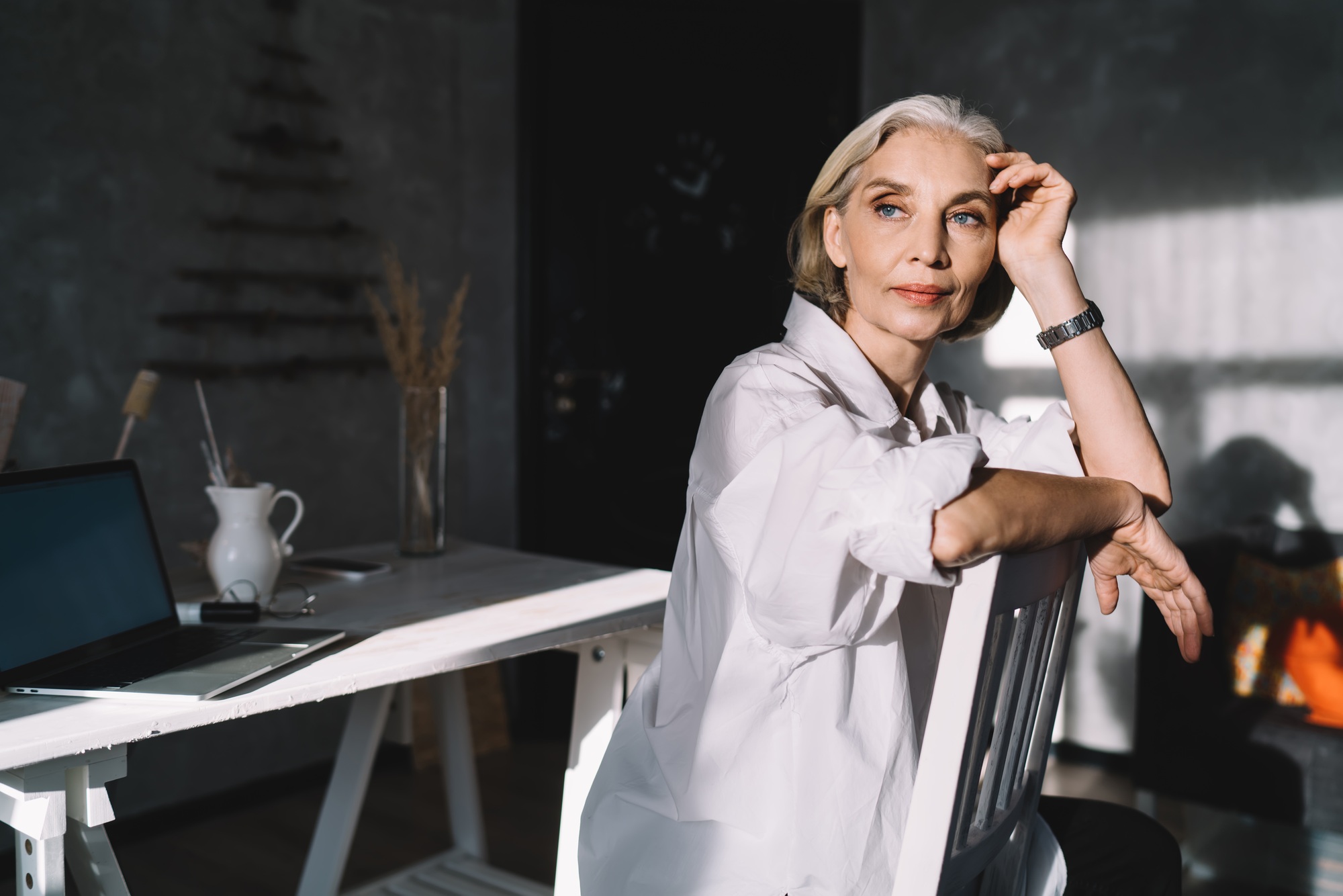 Businesswoman sitting on chair at home art studio