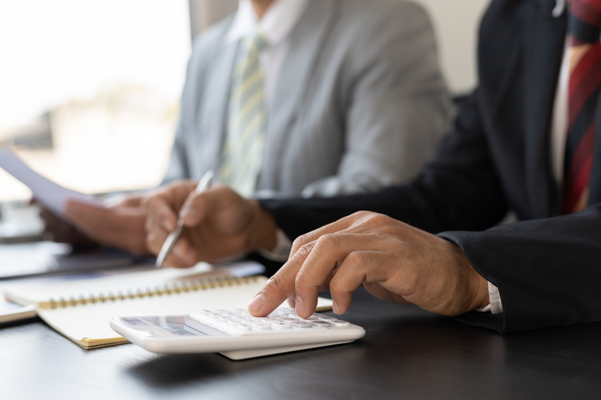 Calculation and analysis of financial statement accounting data on the desk.